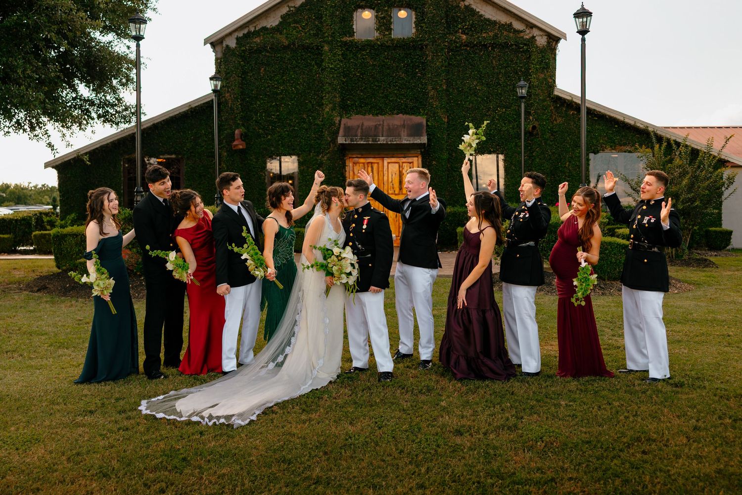A wedding party cheers for the bride and groom in a field outside their wedding venue in Montgomery, Texas.