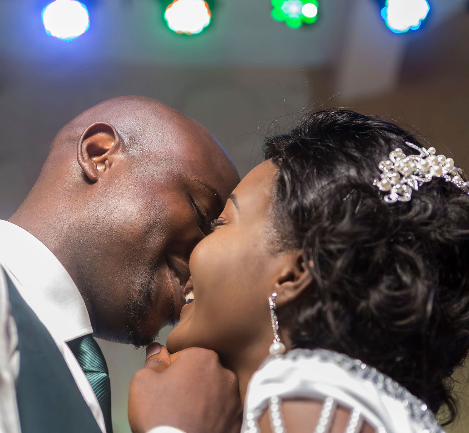 African American bride and groom sharing an intimate moment at their wedding reception.