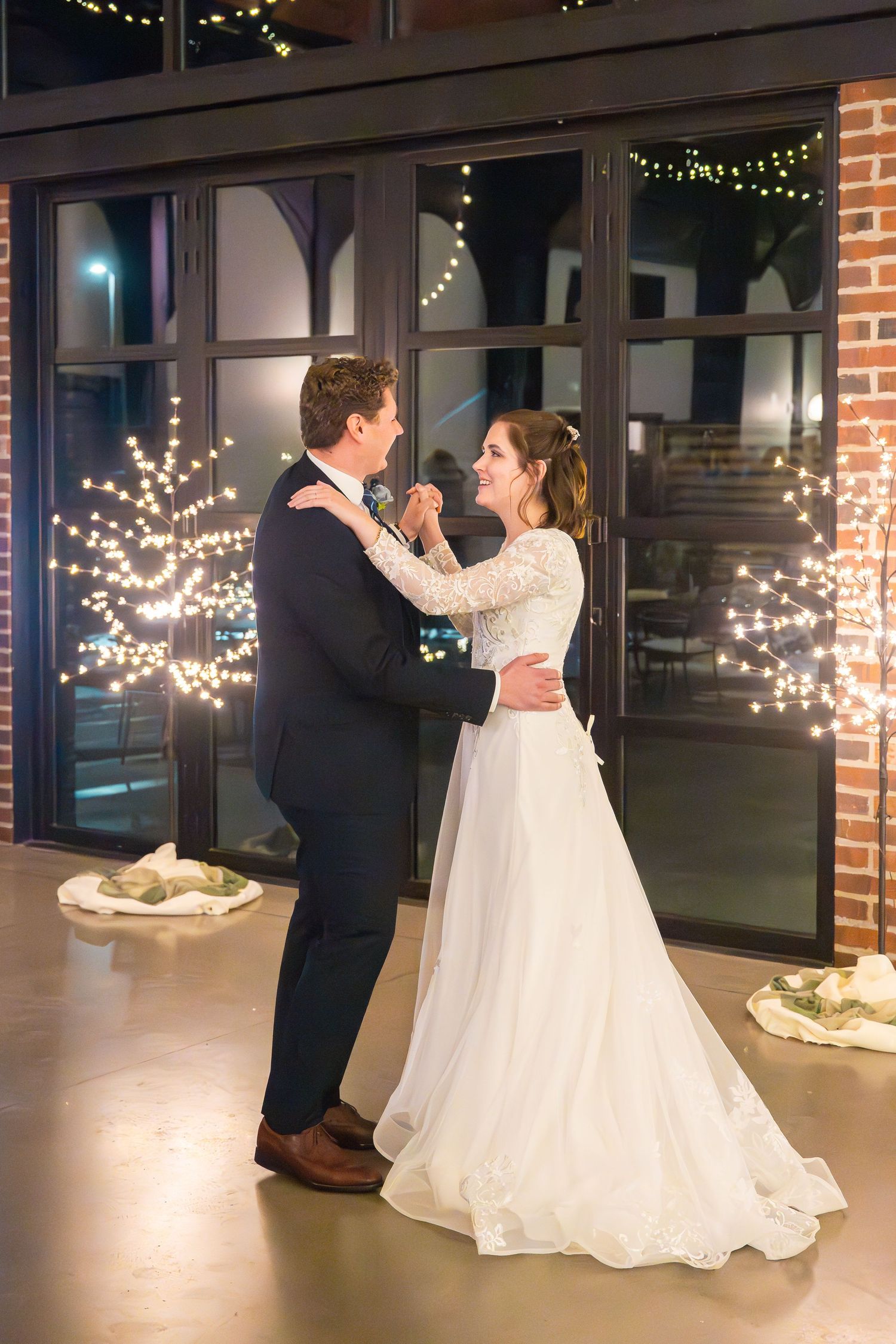 Bride and groom enjoying their first dance during an elegant wedding reception.