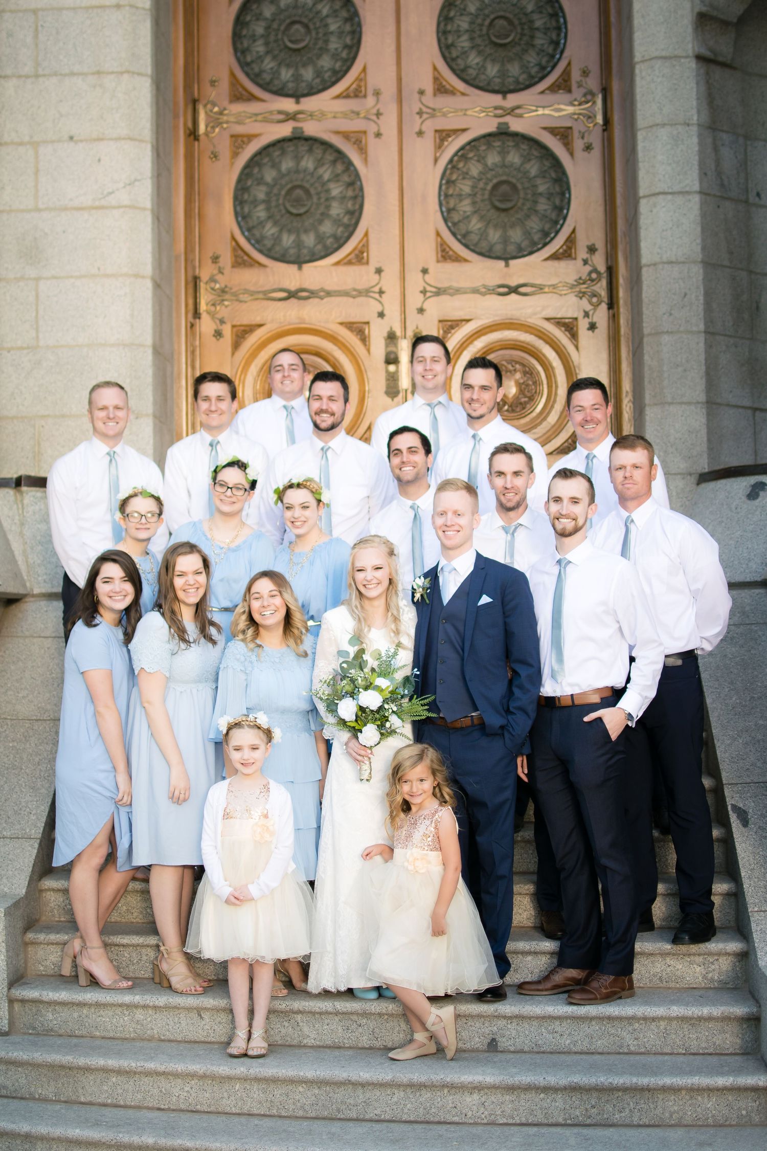 Wedding party gathered outside the LDS temple celebrating the newly married couple.