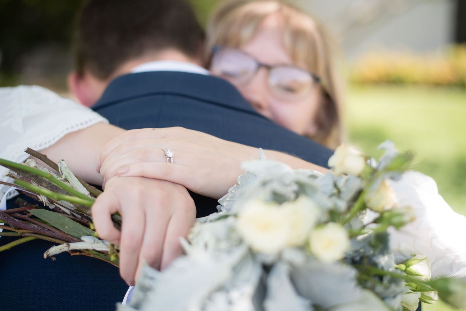Emotional embrace between the bride and a loved one during the wedding celebration.