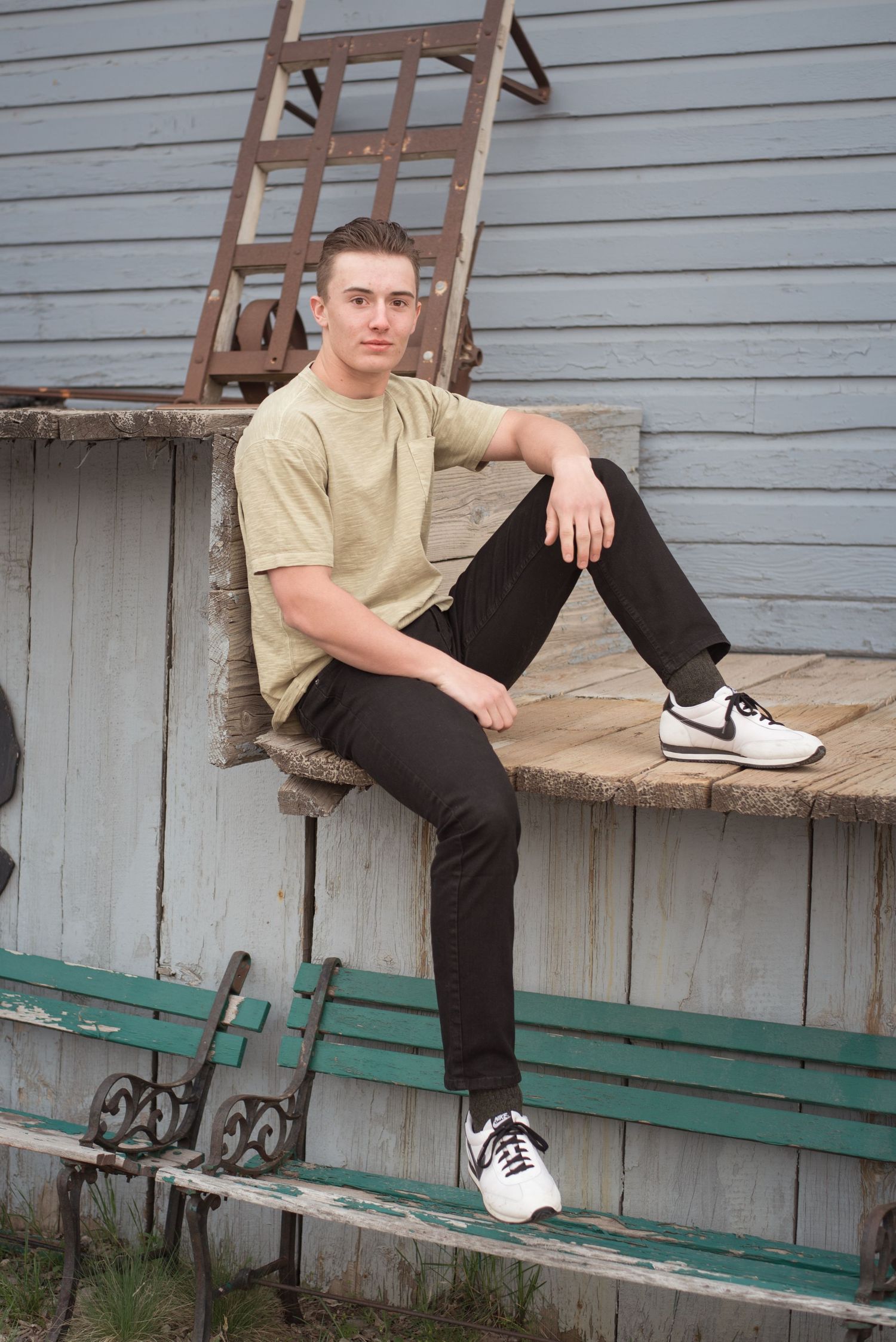 Modern senior portrait featuring a young man in an industrial outdoor location.