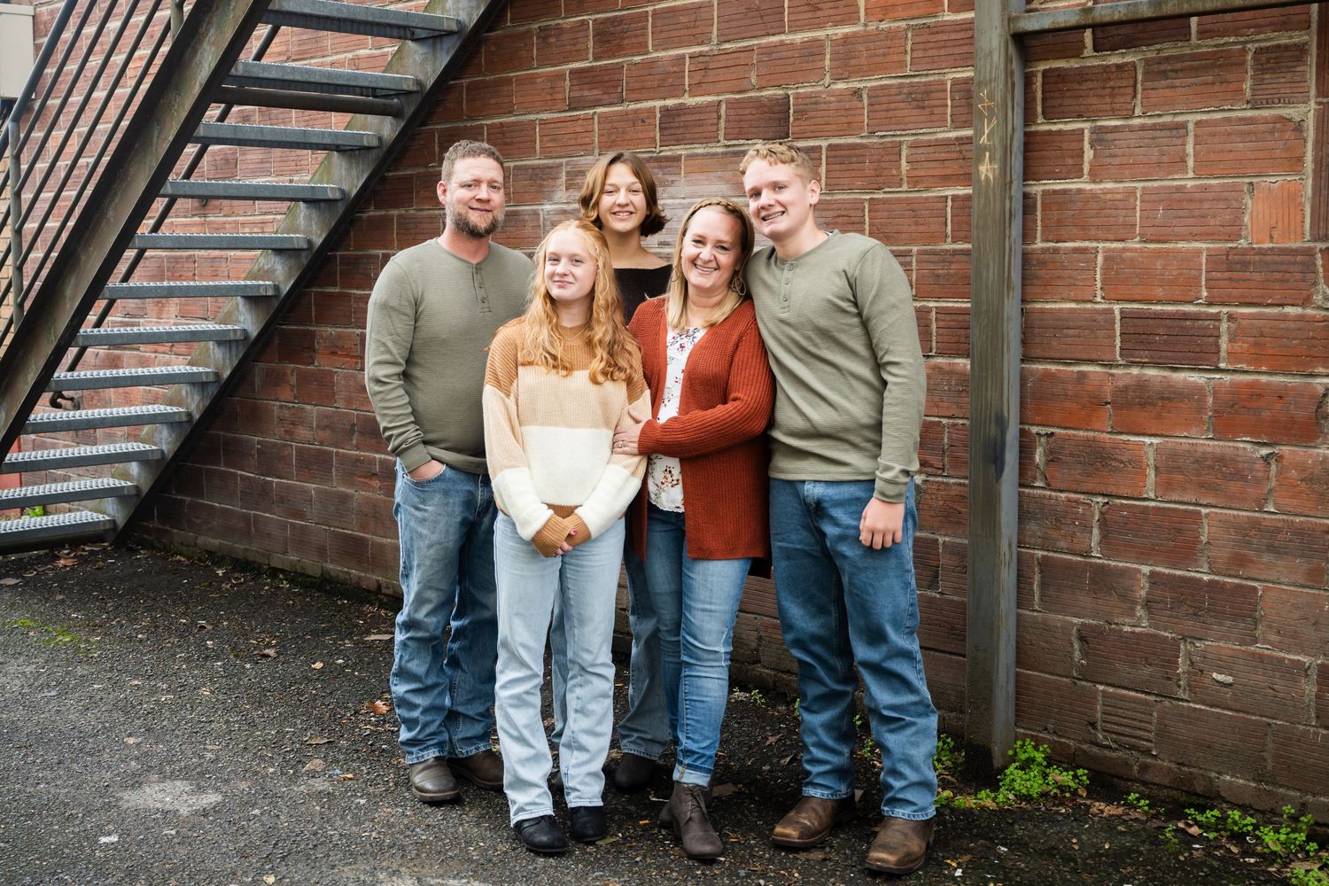 Modern family portrait in an urban setting featuring natural smiles and timeless lifestyle photography.