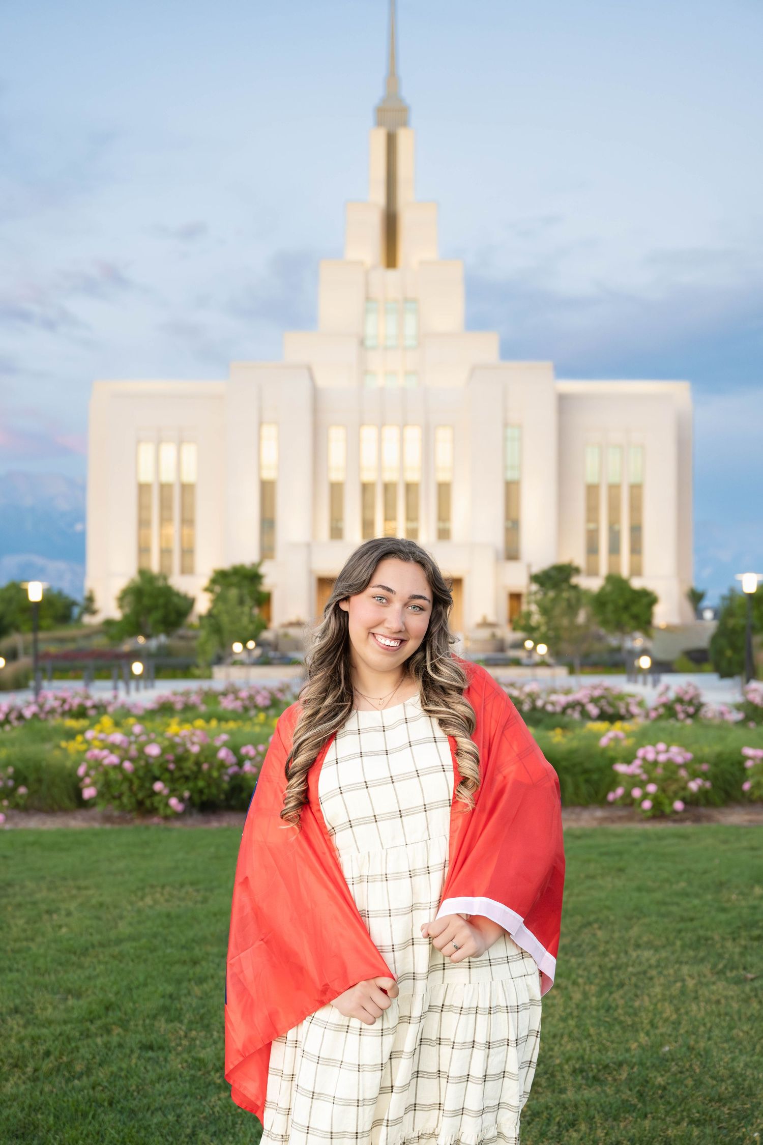 Future missionary portrait in front of the temple with a smiling sister missionary during a spring photography session in Utah County.