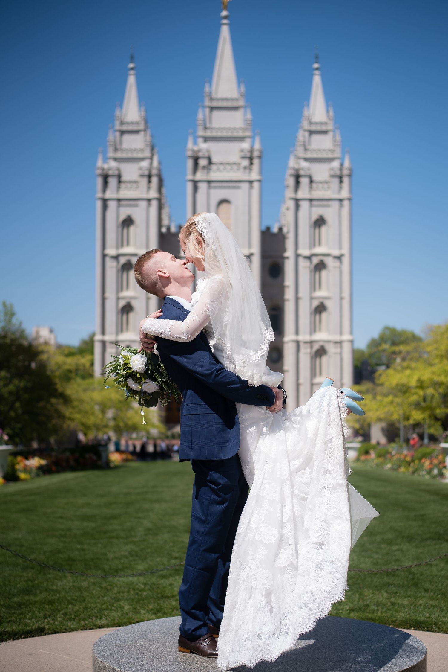 Bride and groom celebrating outside the LDS temple after their wedding ceremony.