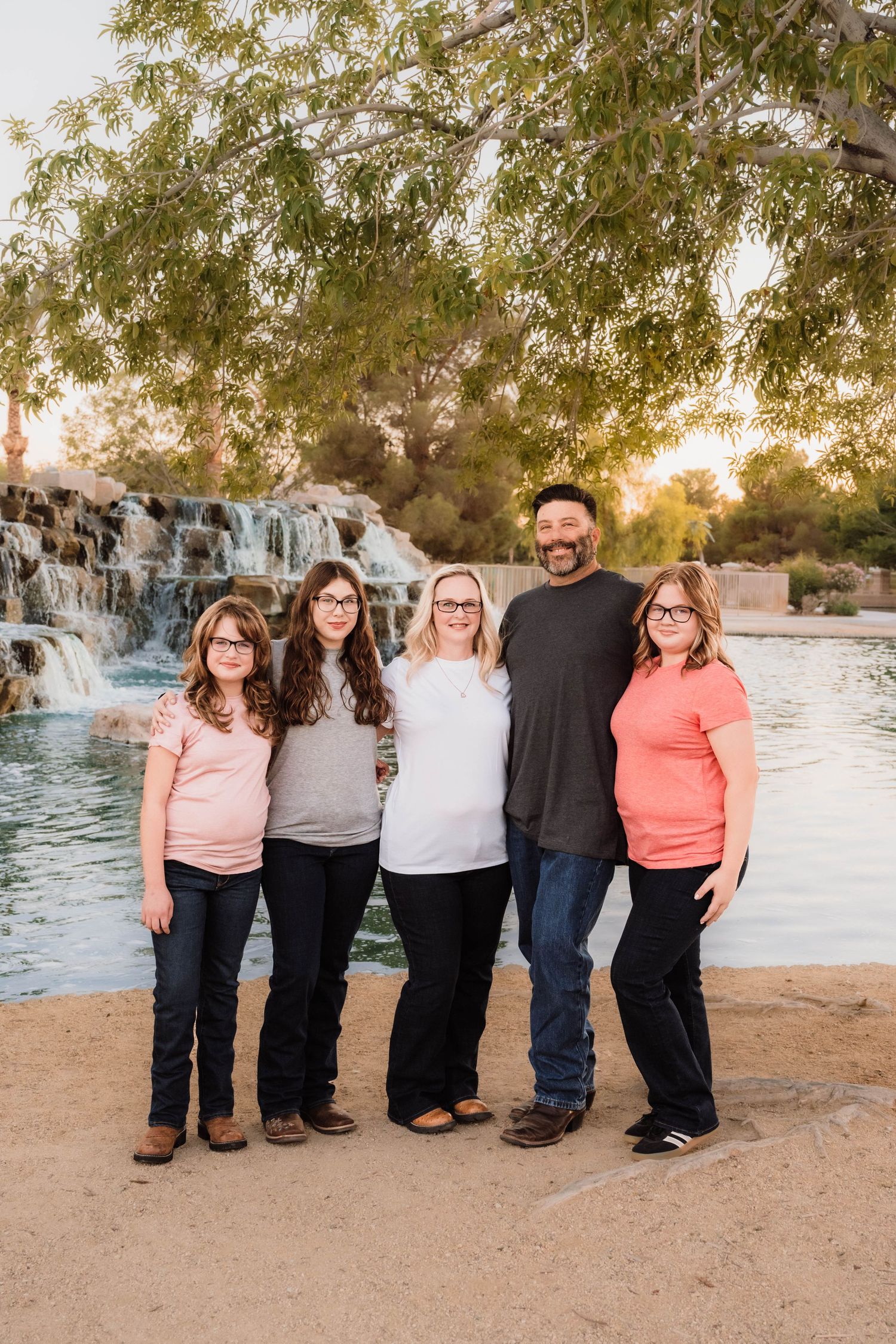 Family gathered together at sunset during a beautiful outdoor family photography session.