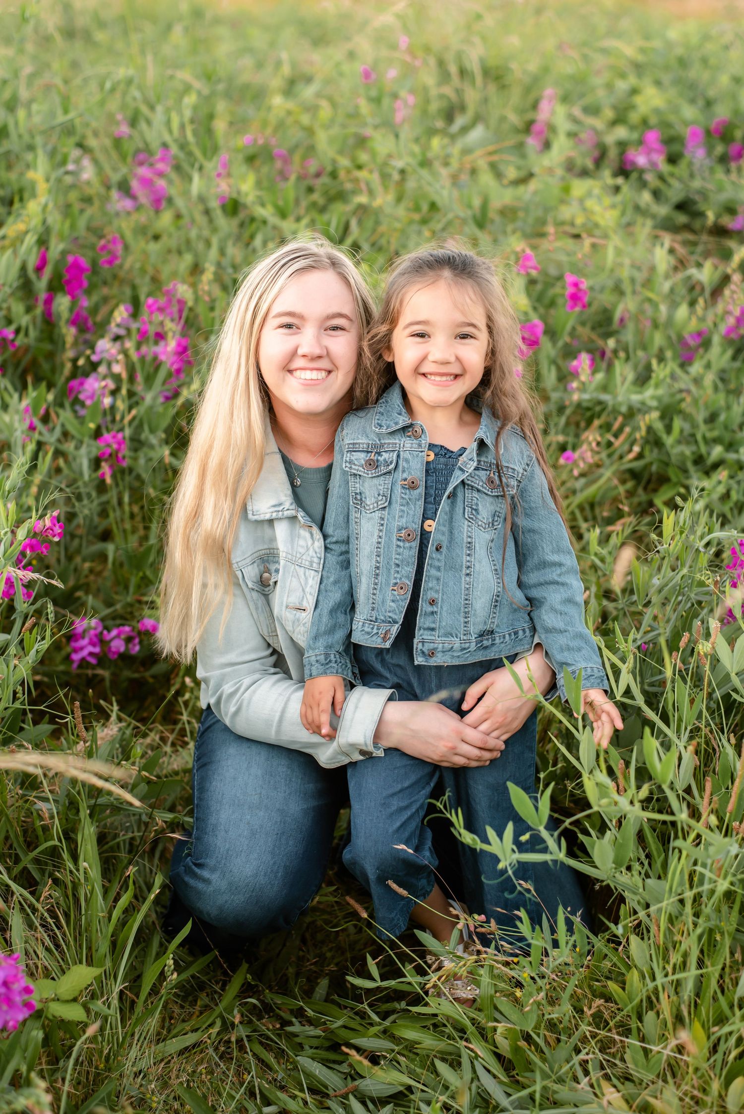 Natural light mother and daughter portrait surrounded by colorful wildflowers.