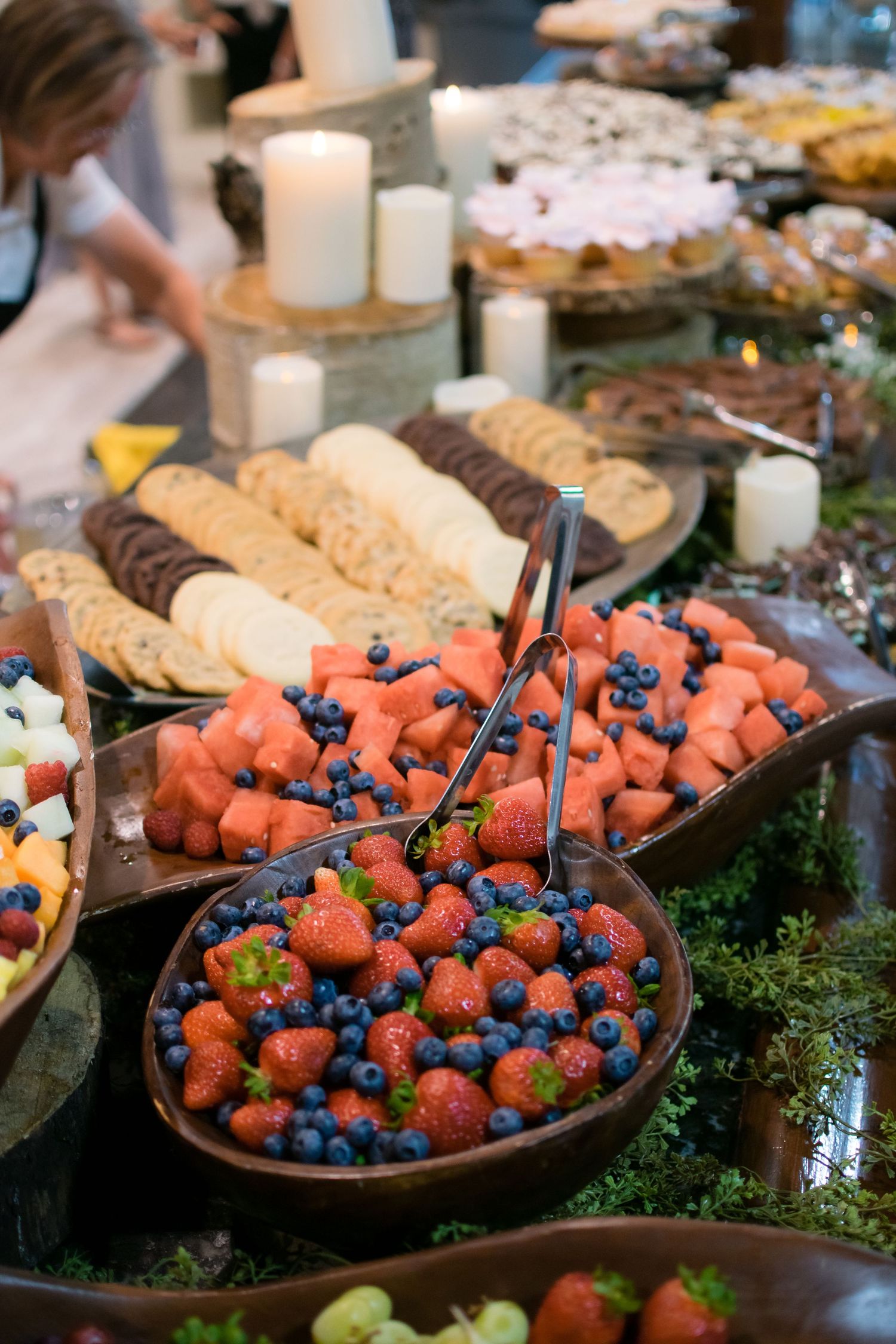 Elegant wedding dessert display featuring fresh berries, desserts, and reception treats beautifully arranged for guests.