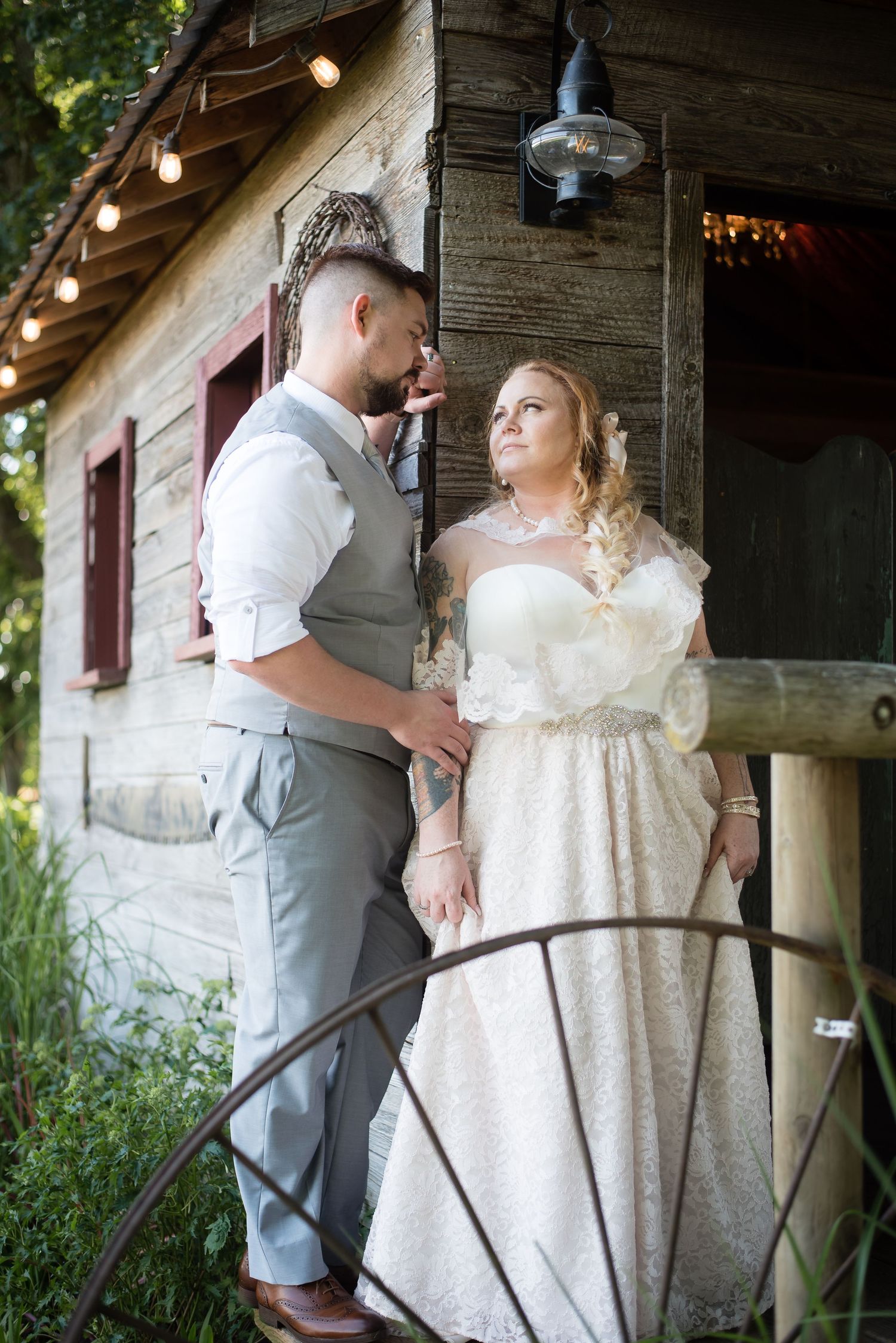 Bride and groom sharing a quiet moment together inside a rustic wedding venue.