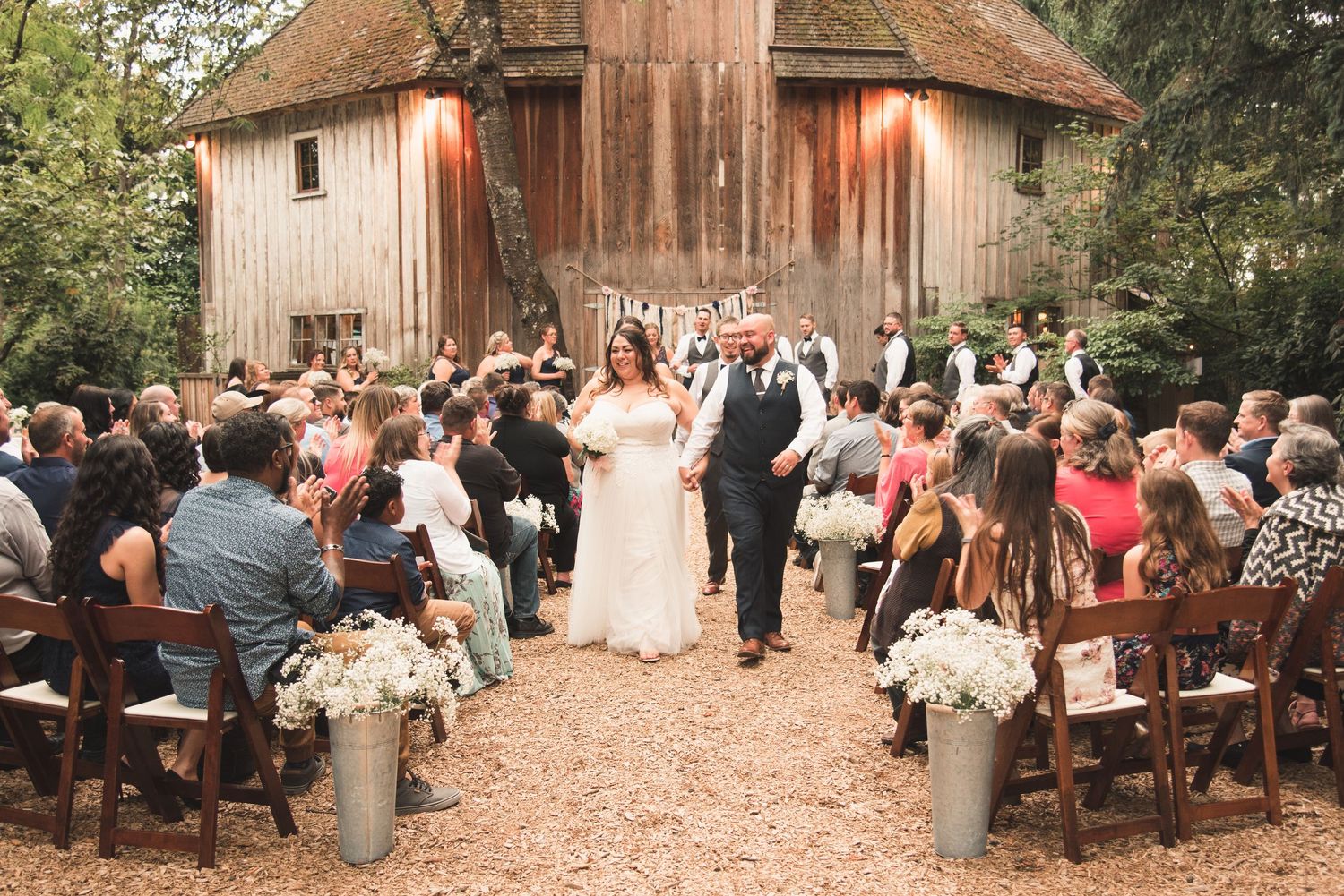Outdoor wedding ceremony with bride and groom exchanging vows in front of family and friends.