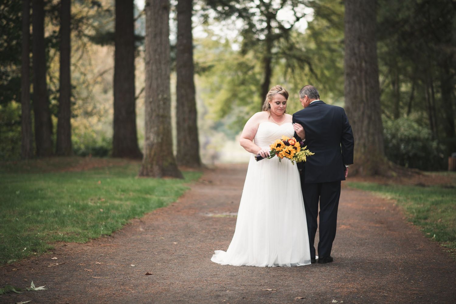 Romantic wedding portrait featuring newlyweds surrounded by beautiful forest scenery.