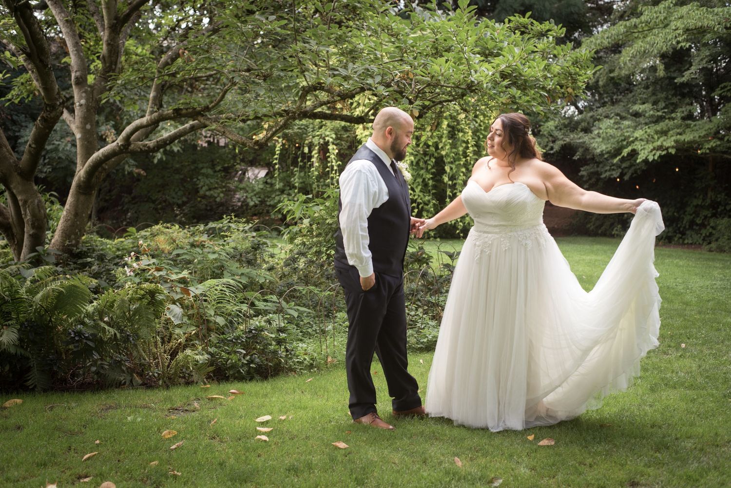 Romantic wedding portrait featuring the bride and groom in a beautiful garden setting.