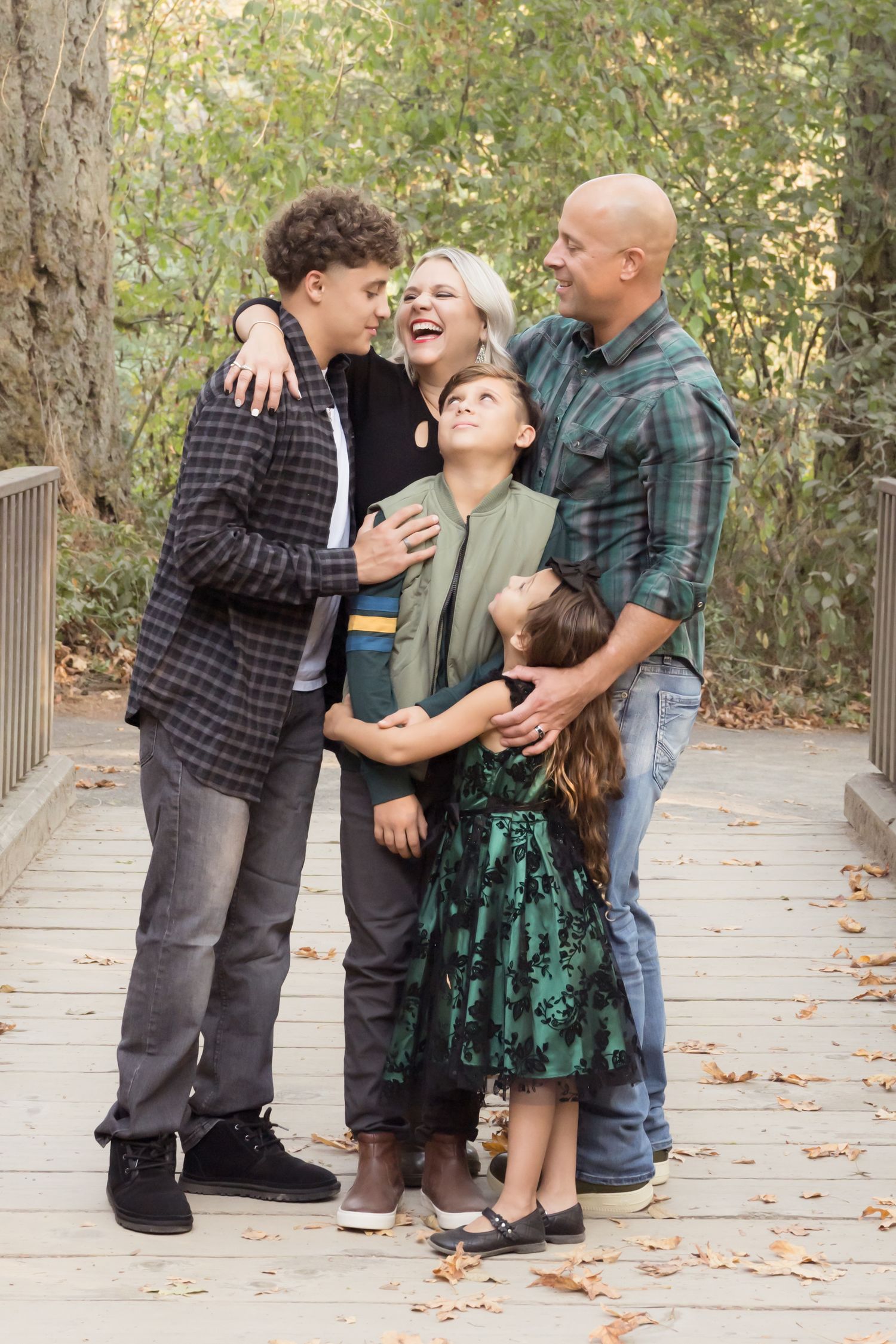 Family embrace during a natural outdoor portrait session.