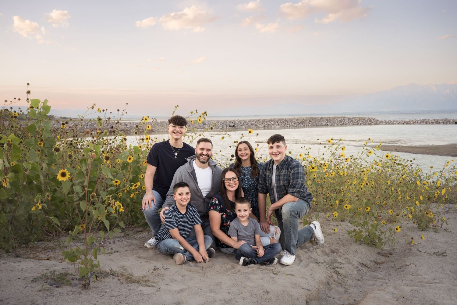 Family gathered together during an outdoor family photography session by Utah Lake.