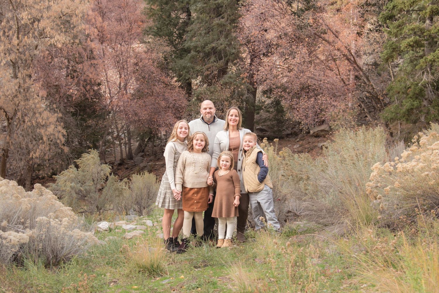 Natural light family portrait captured in a beautiful autumn landscape.
