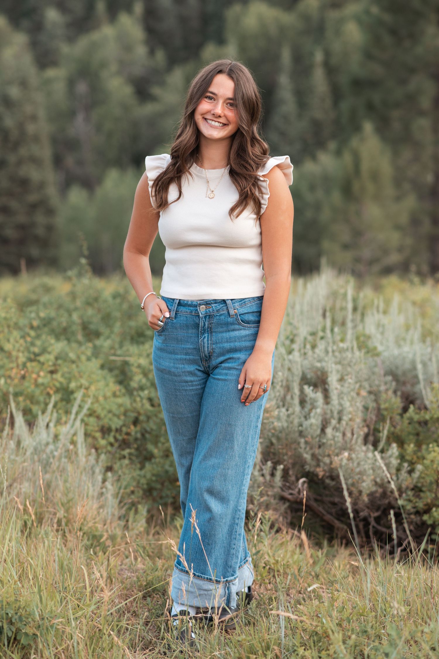 Full-length senior portrait captured outdoors with natural light, showcasing confidence and personality during a Utah senior photography ses