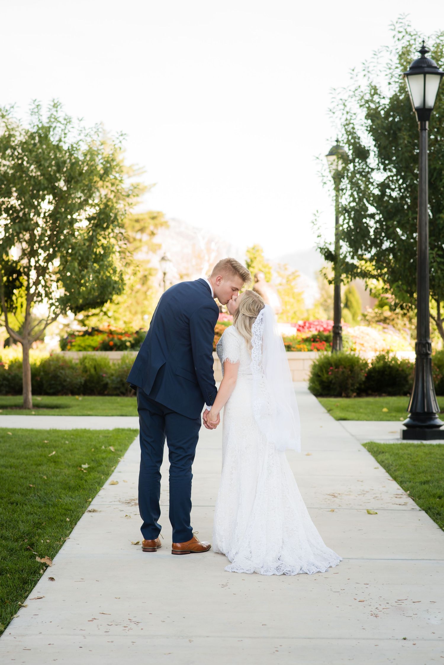 Bride and groom walking together during an outdoor wedding photography session at Provo, UT temple.