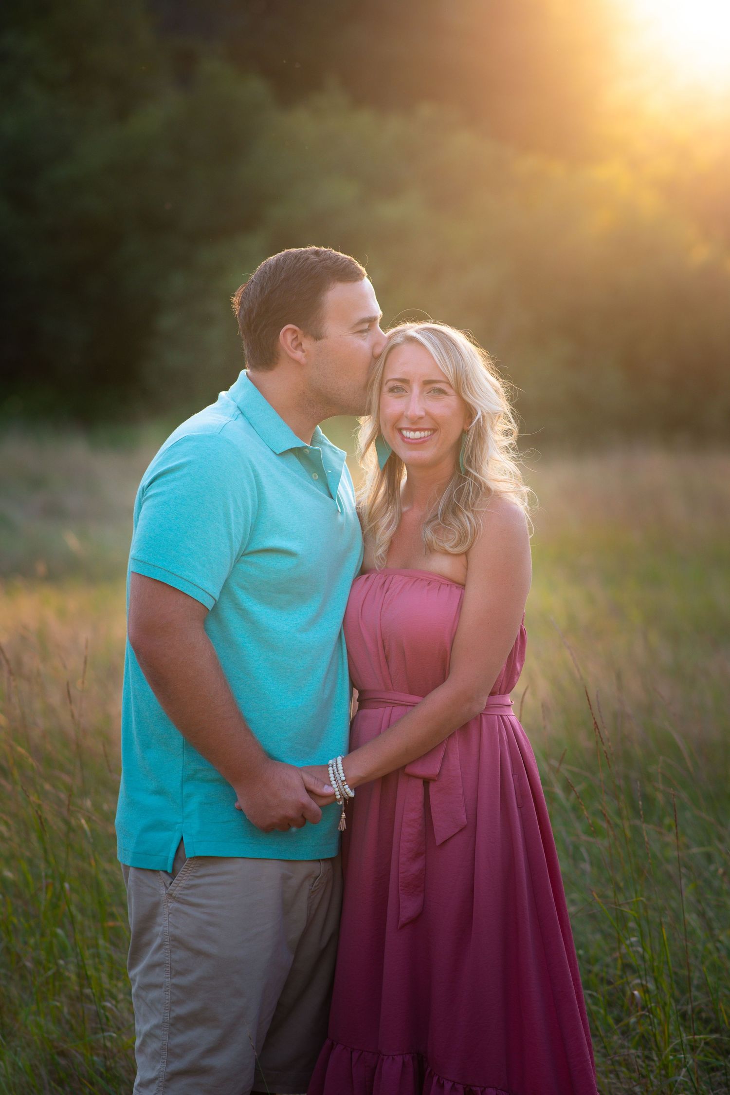 Couple embracing during golden hour in an open field, capturing a romantic outdoor portrait session in beautiful Clark County, WA.
