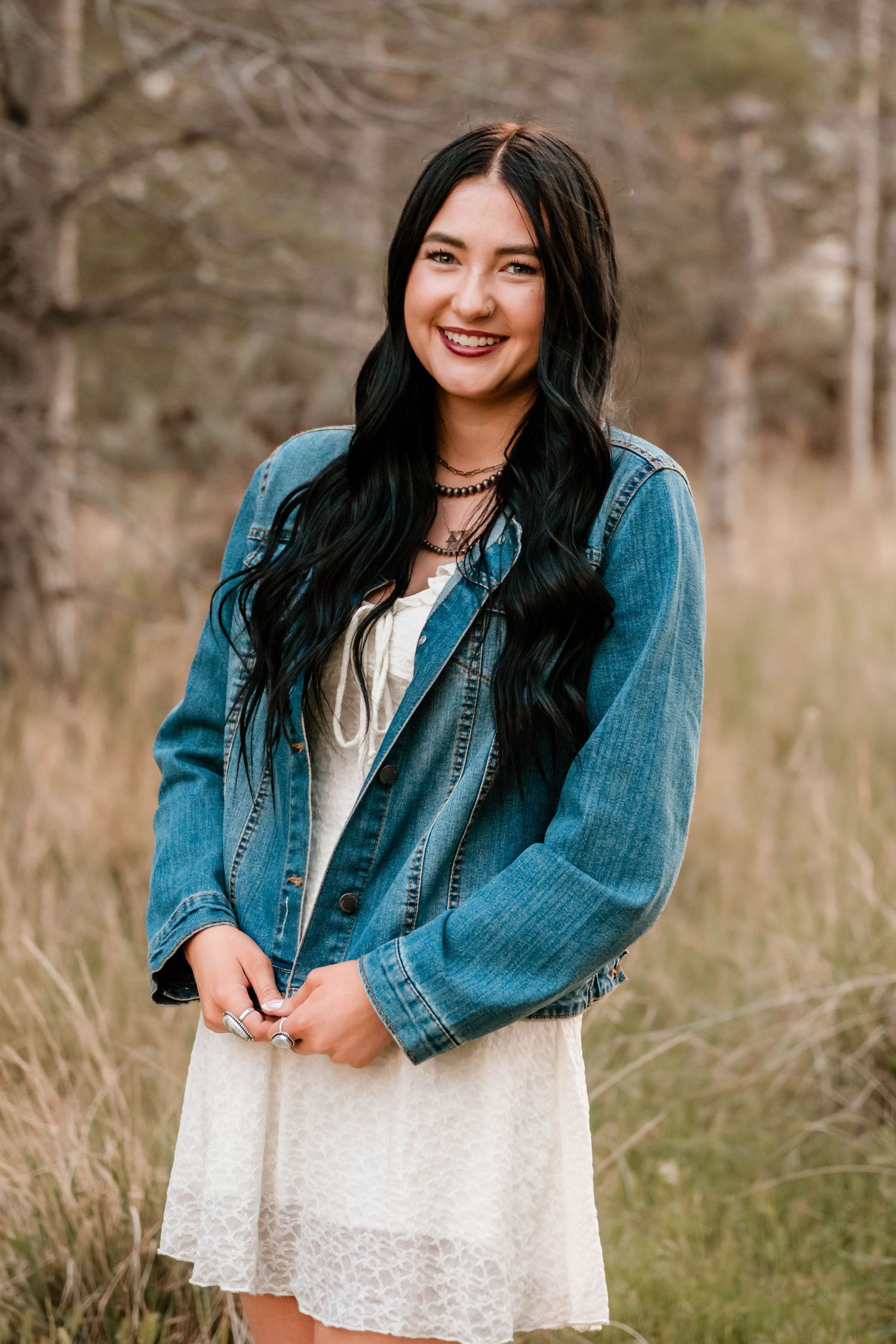 High school senior girl smiling during an outdoor senior photography session in Utah.