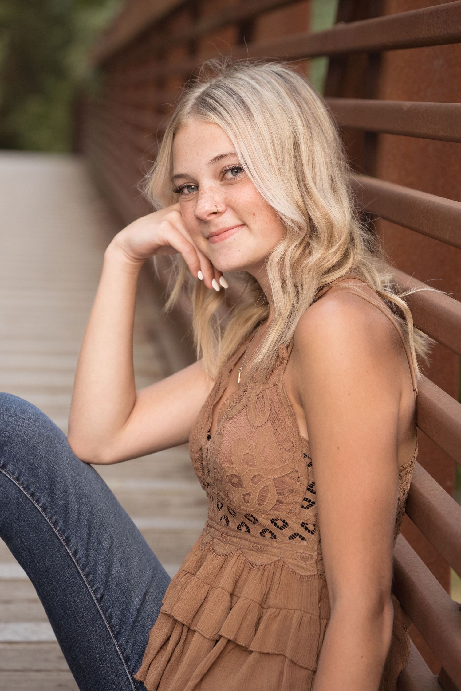 High school senior girl posing on a pedestrian bridge during a senior photography session in Washington.
