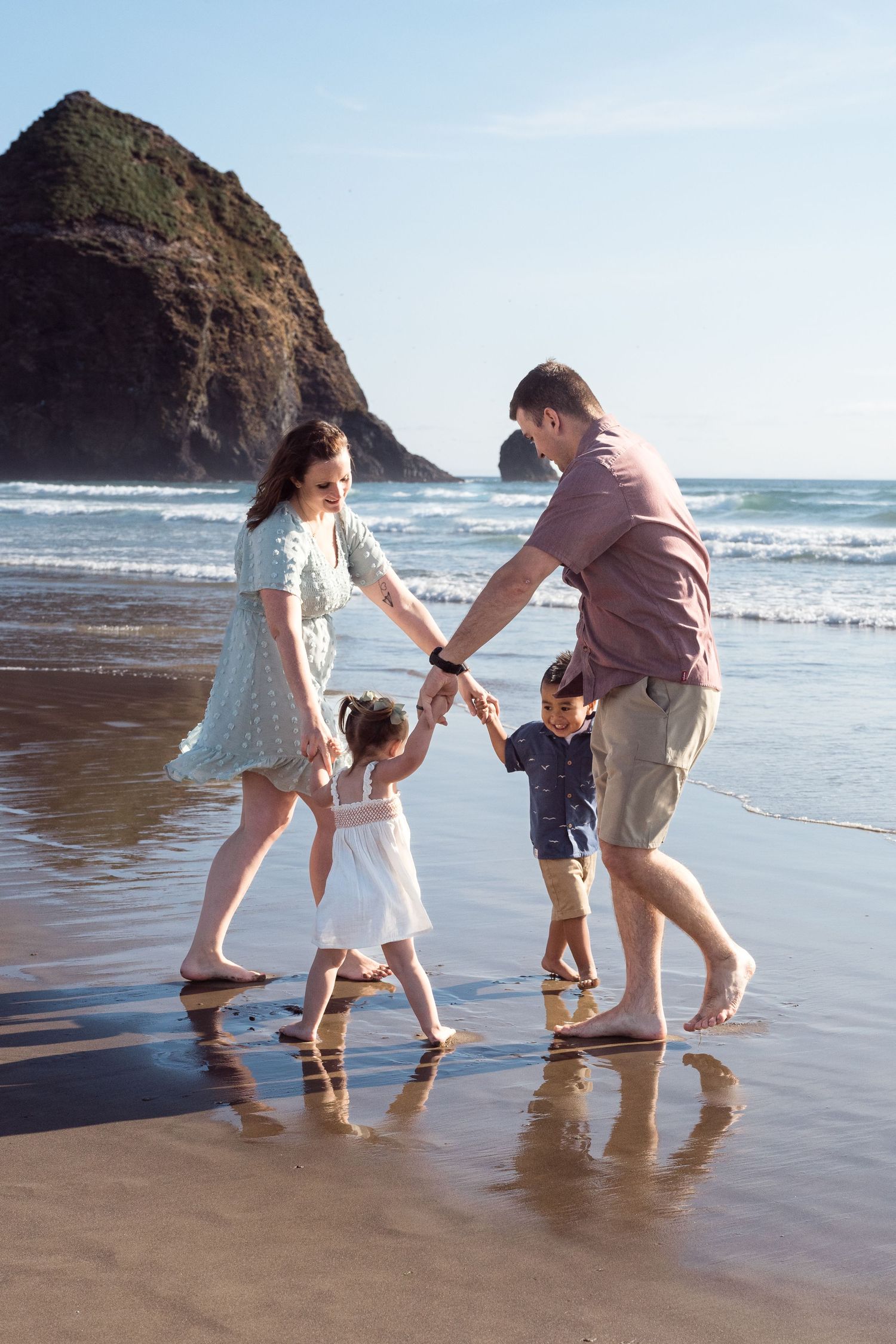 Family playing along the beach during a fun and candid coastal family session.