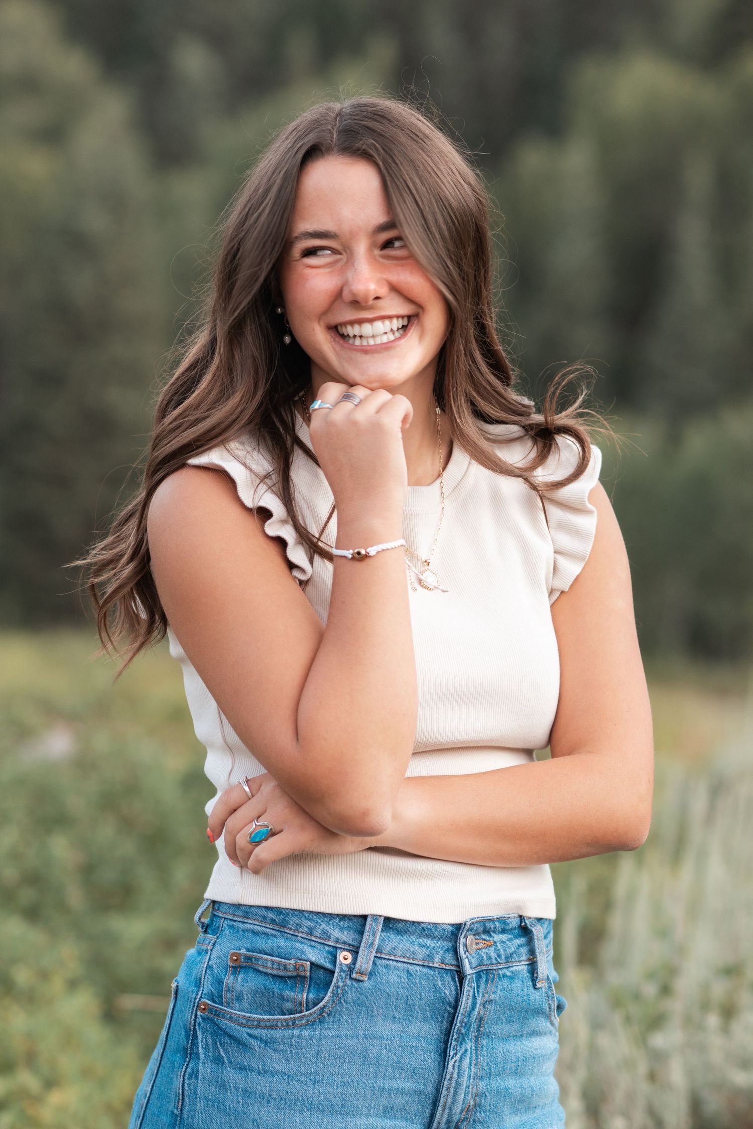 Natural high school senior portrait featuring a smiling senior during a relaxed outdoor photography session in Utah County.