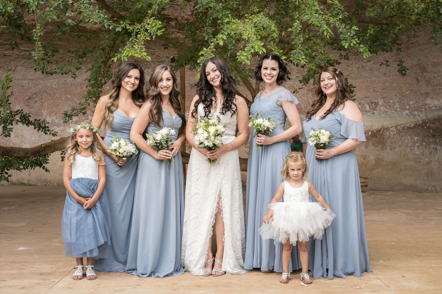 Bride celebrating with her bridesmaids during joyful wedding portraits before the ceremony.