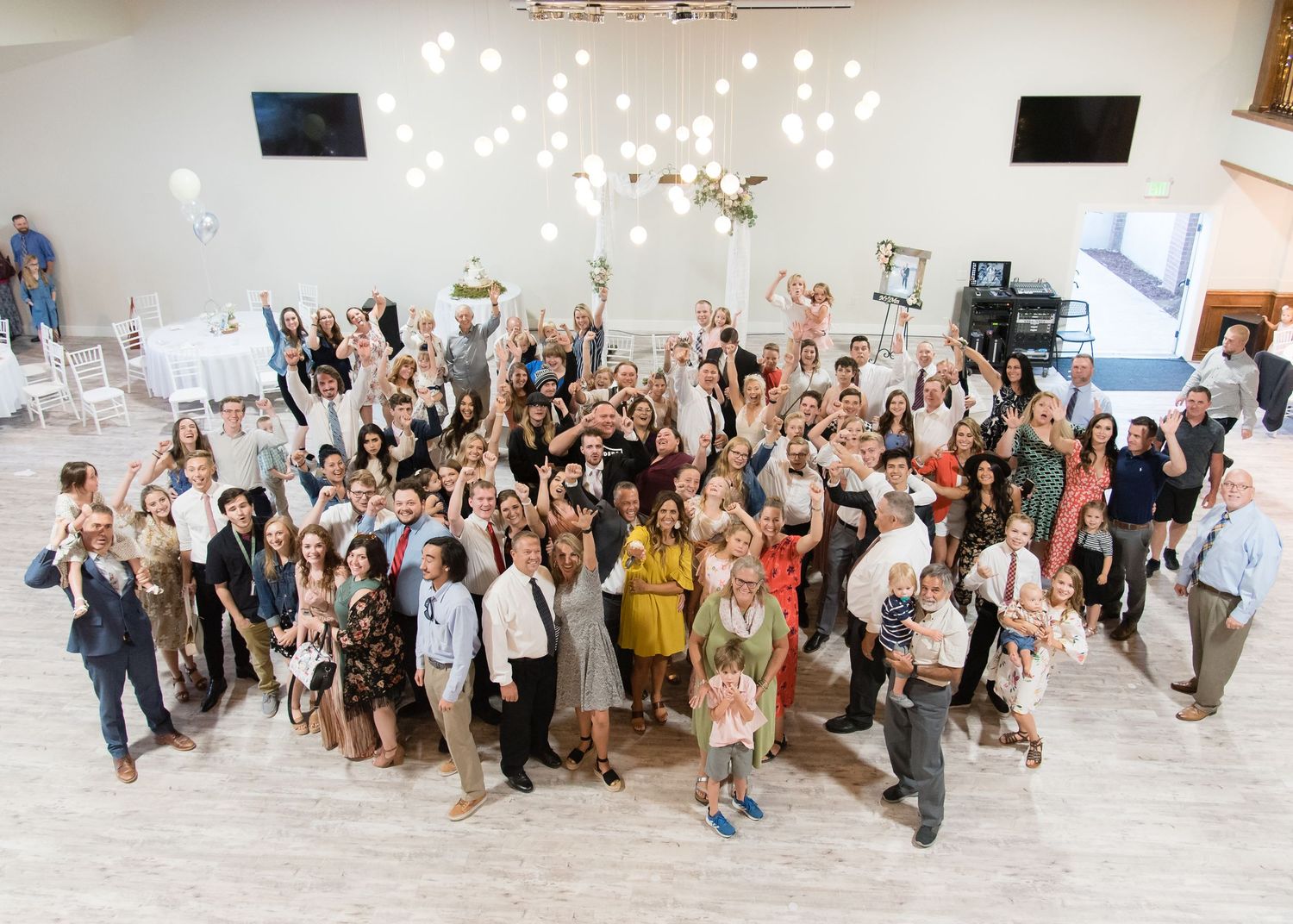 Wedding guests celebrating together on the dance floor during a fun-filled reception.