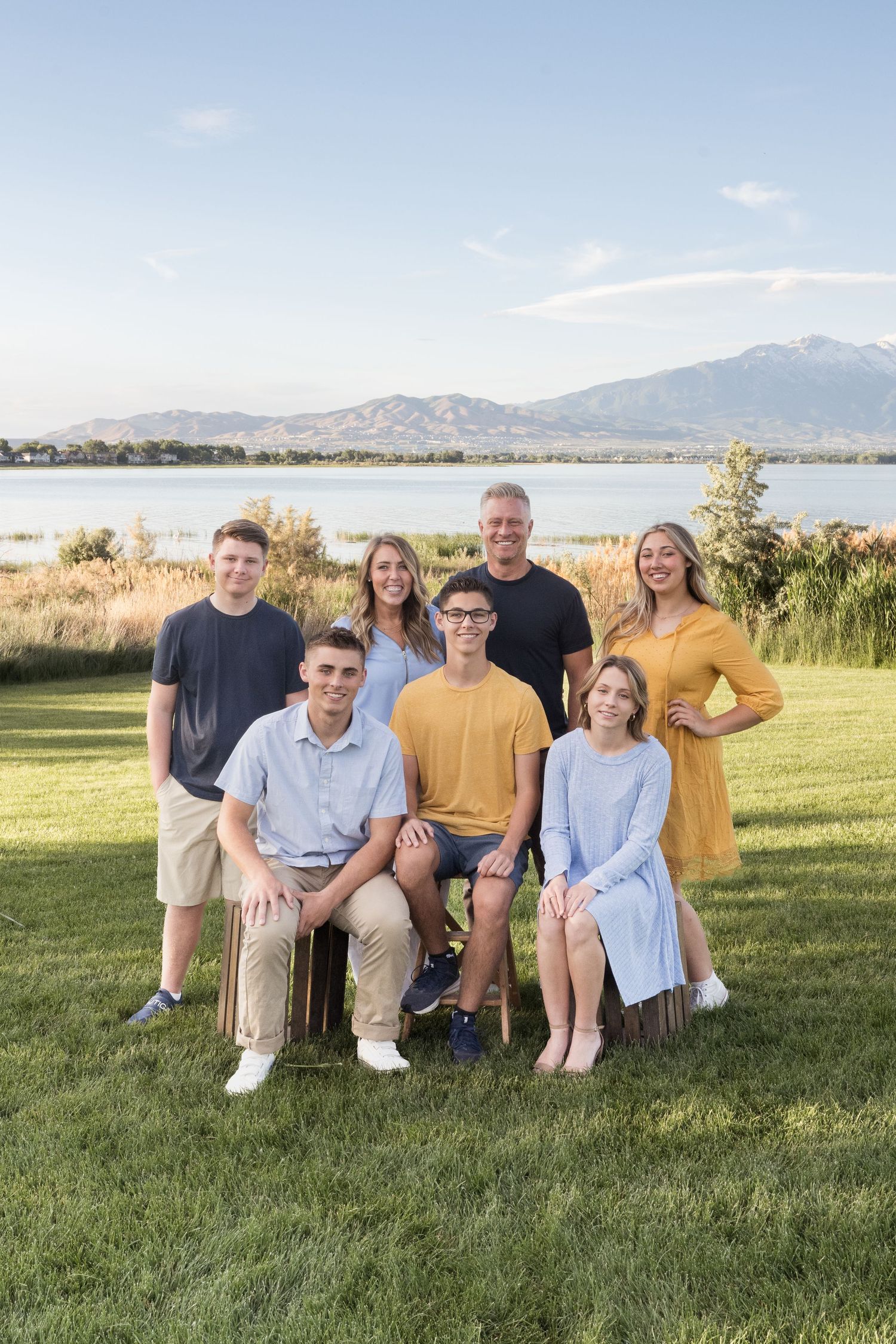 Family of seven smiling together during an outdoor family photography session in Utah County.