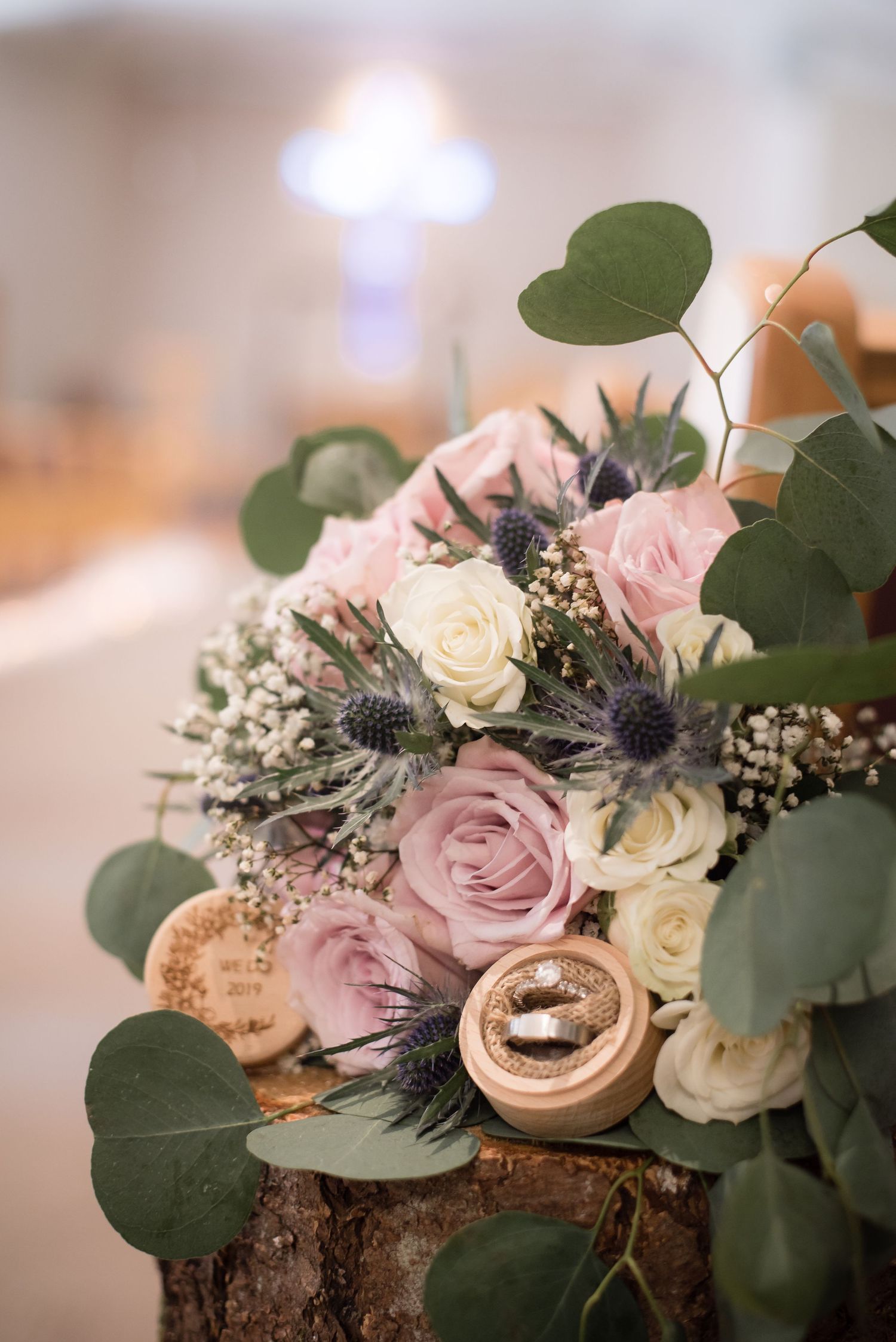 Wedding bouquet with rings and floral details captured during the wedding celebration.