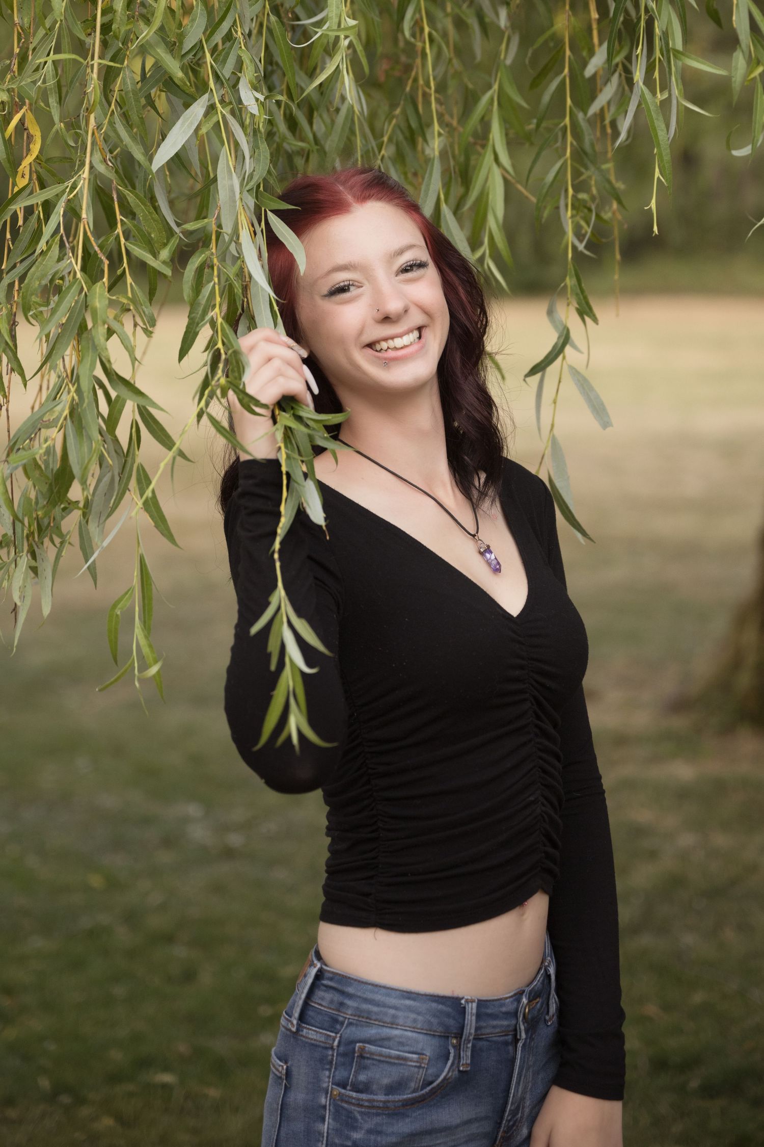 High school senior smiling during an outdoor photography session in Battle Ground, WA