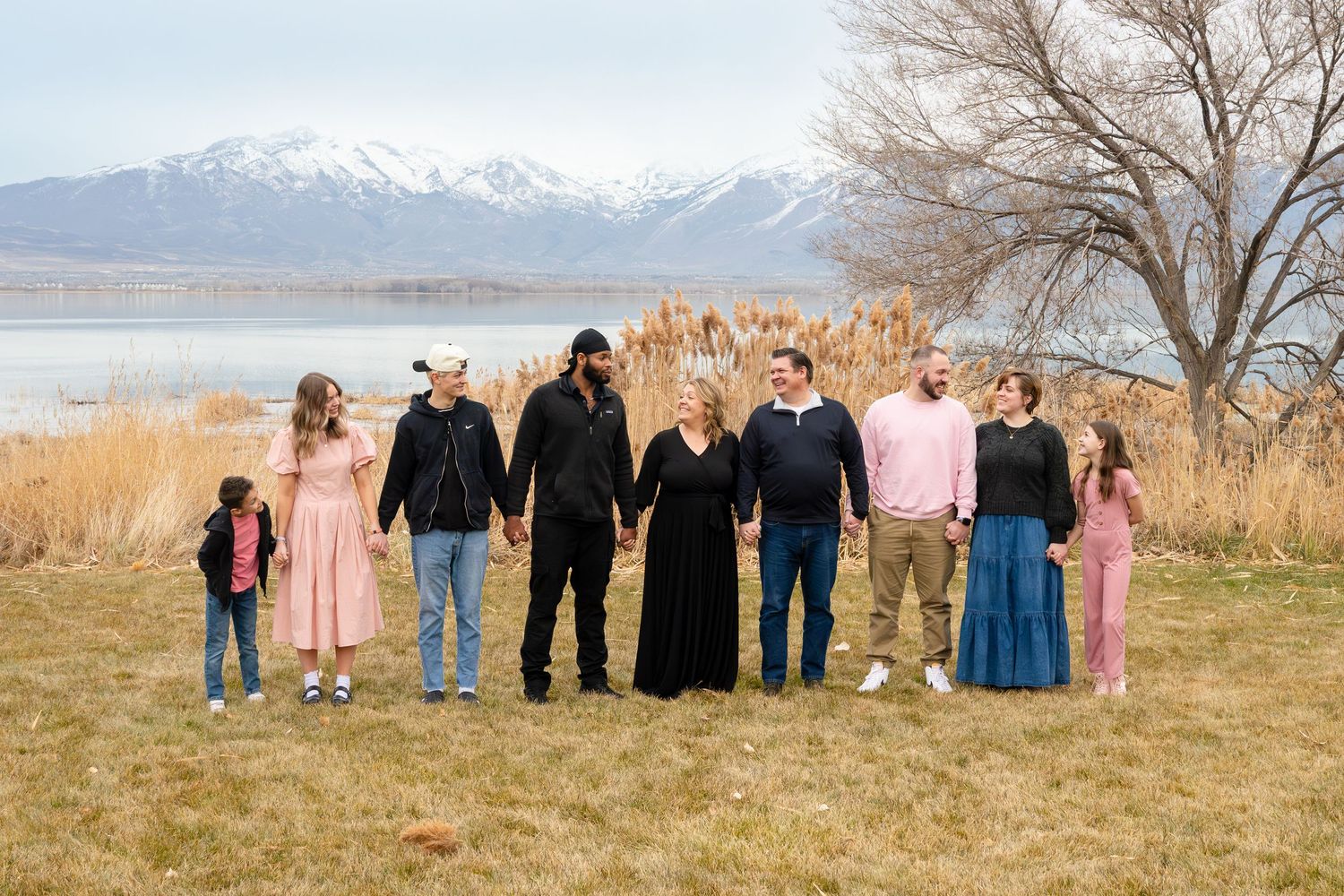 Extended family gathered together for an outdoor family photography session with mountain views in Utah.