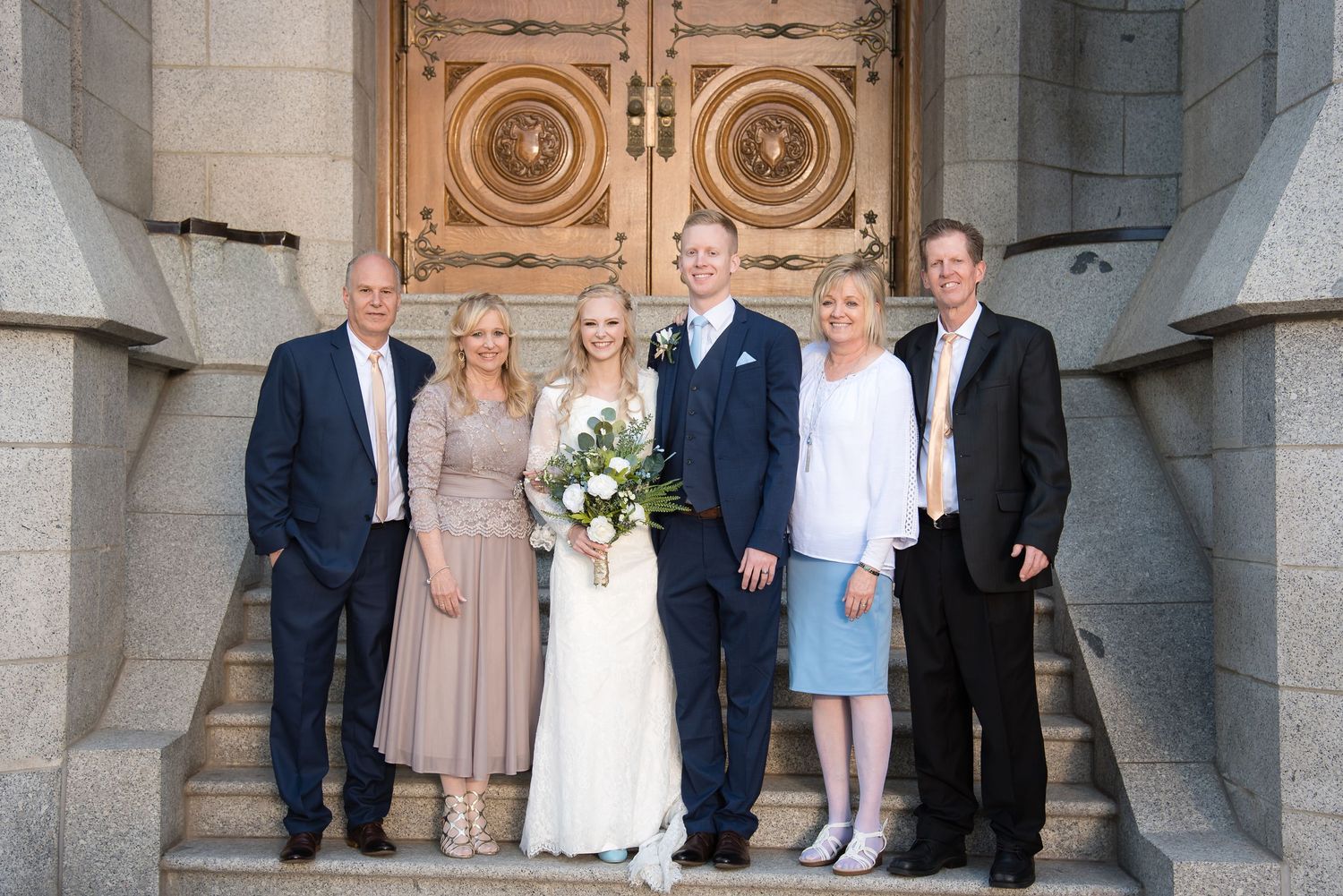Bride and groom with family outside the LDS temple following their wedding ceremony.