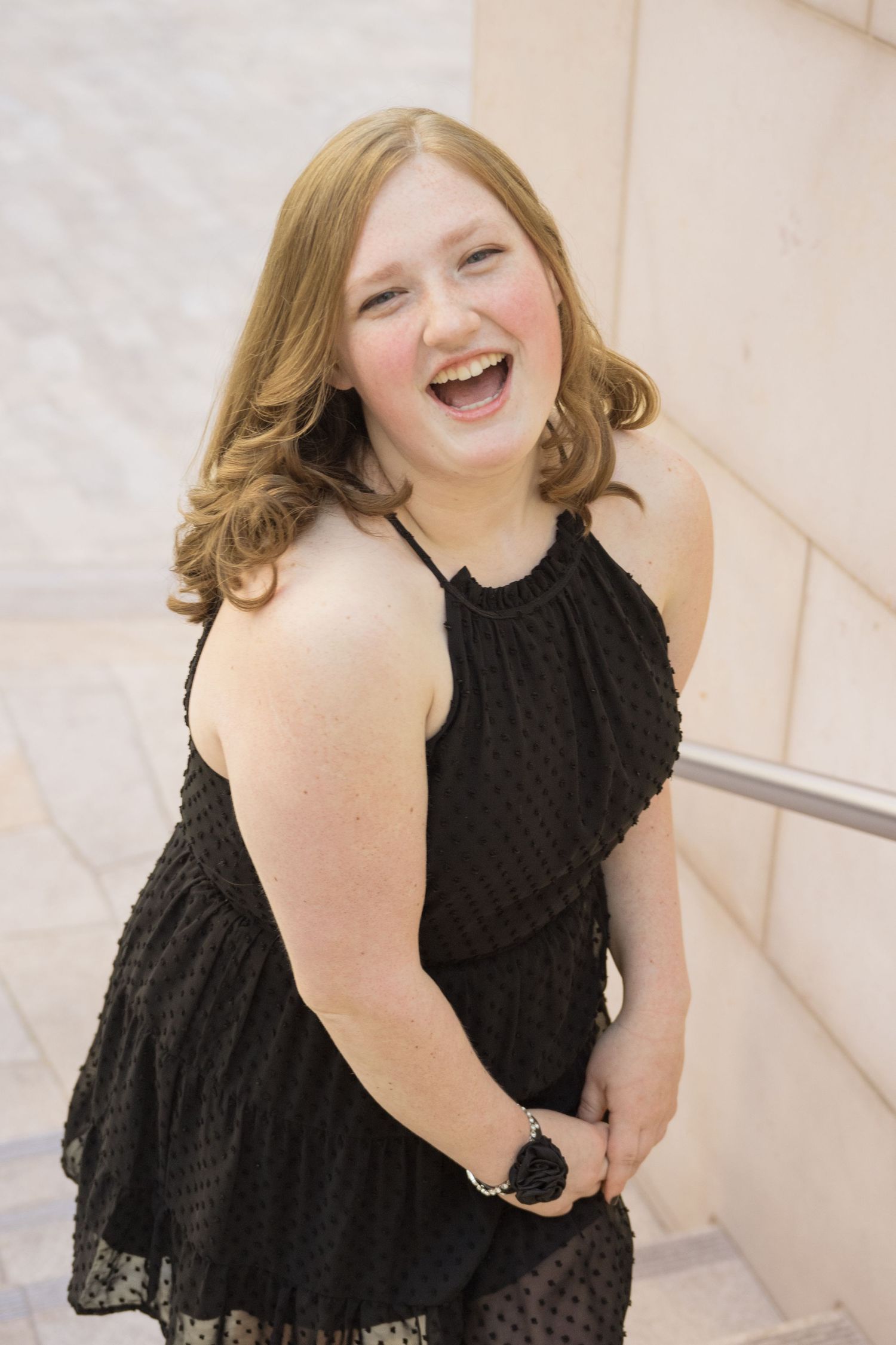 High school senior girl laughing during an outdoor senior photography session in Utah.