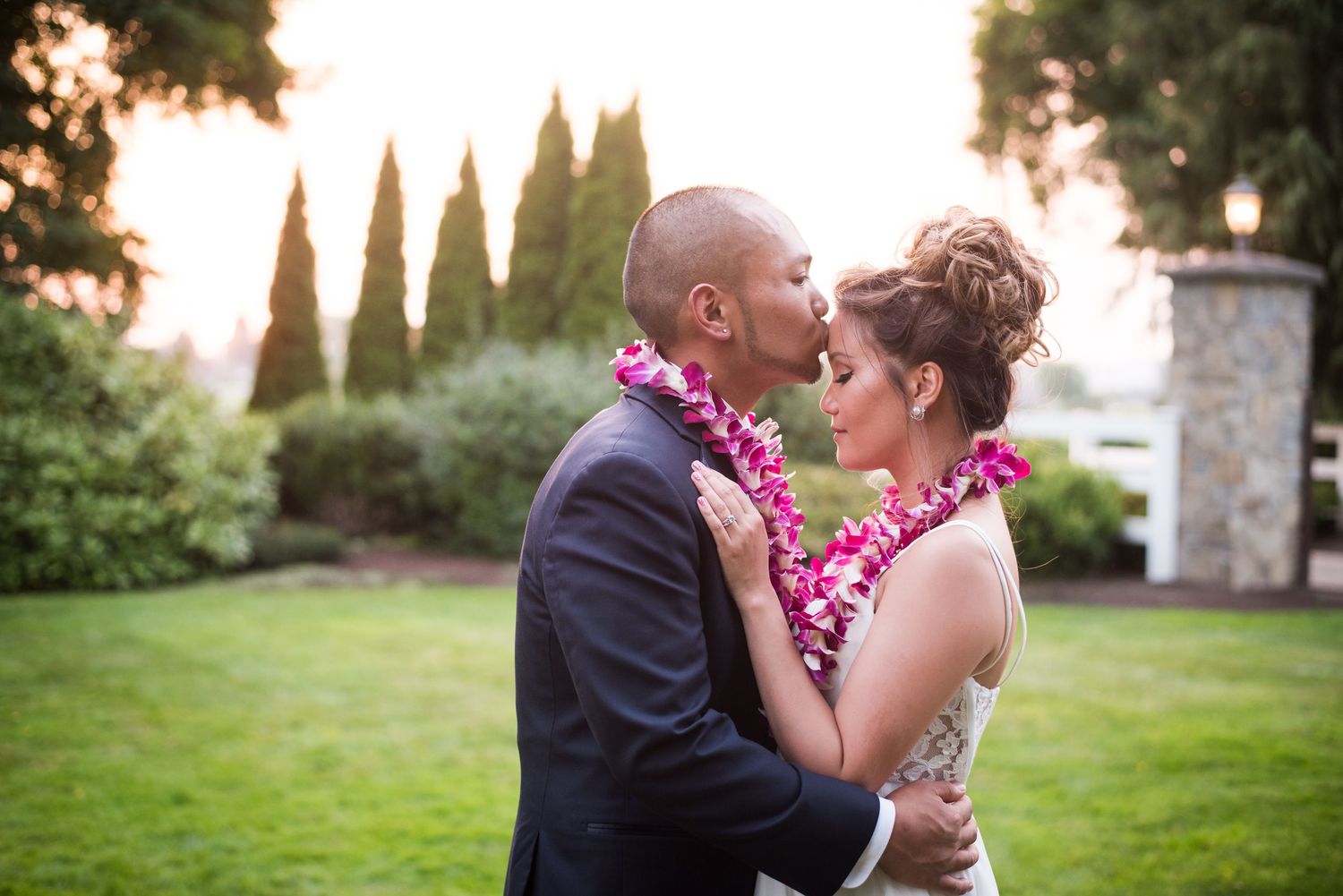 Romantic wedding portrait featuring newlyweds embracing in a beautiful garden setting.