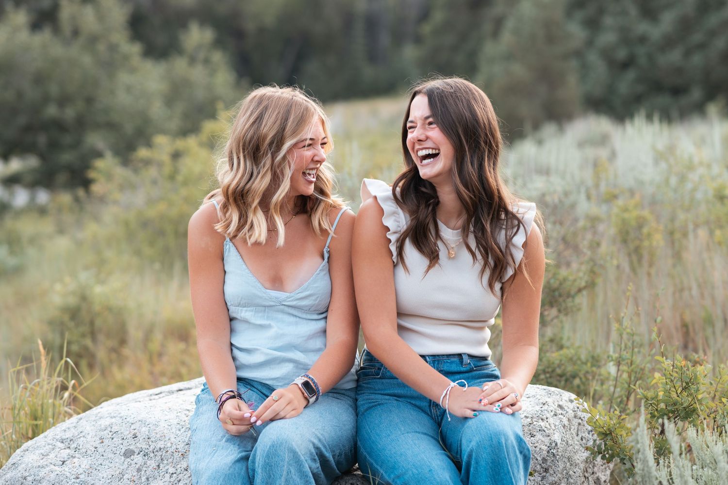 Best friends laughing together during an outdoor portrait photography session in Utah.
