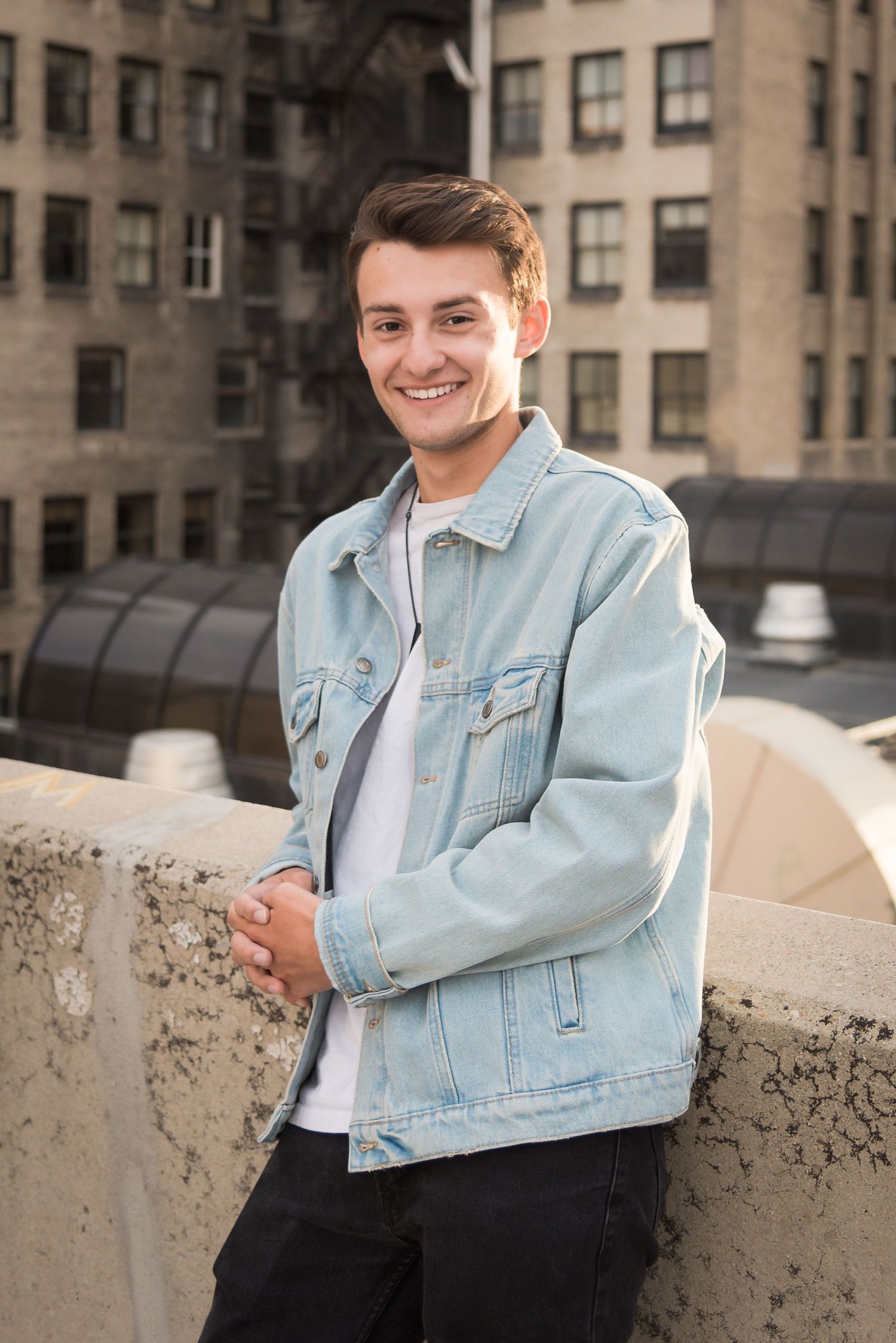 Modern senior portrait featuring a young man in a downtown city setting.