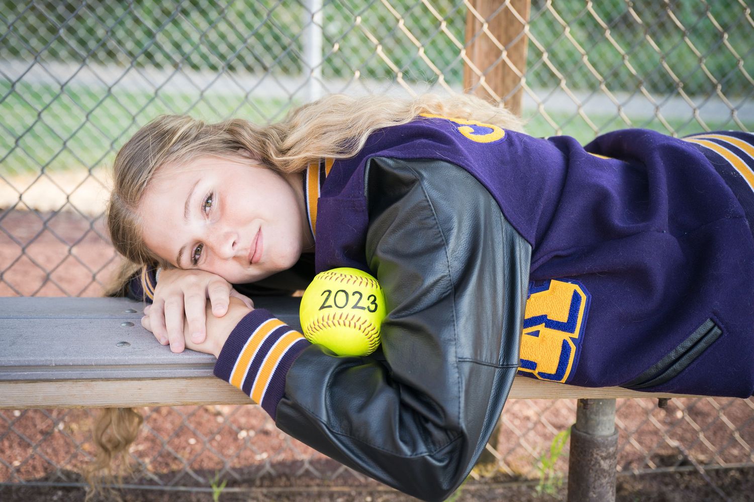 Senior sports portrait featuring a student-athlete celebrating her love of softball.