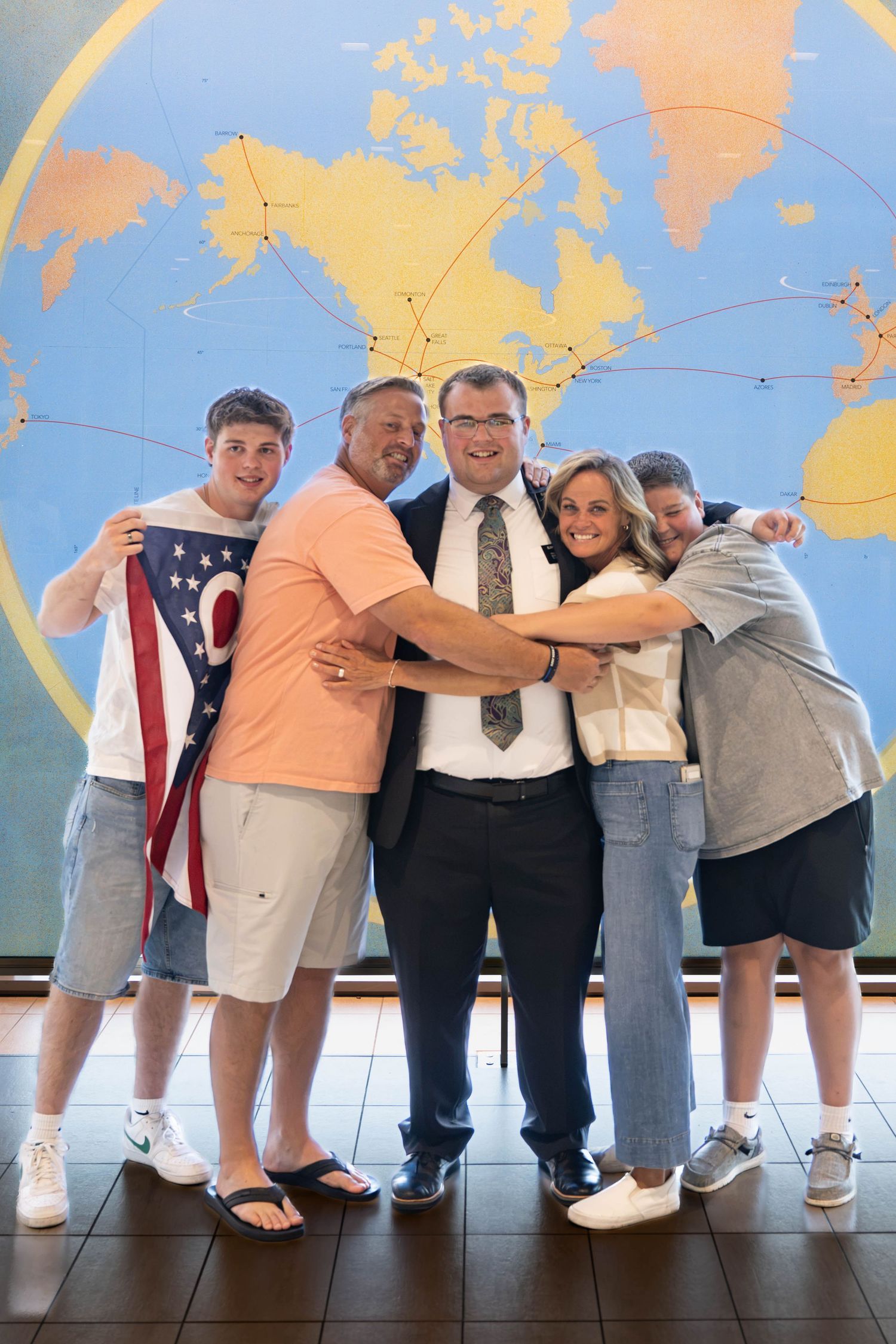 Emotional LDS missionary airport homecoming with family celebrating a joyful reunion after returning from missionary service.