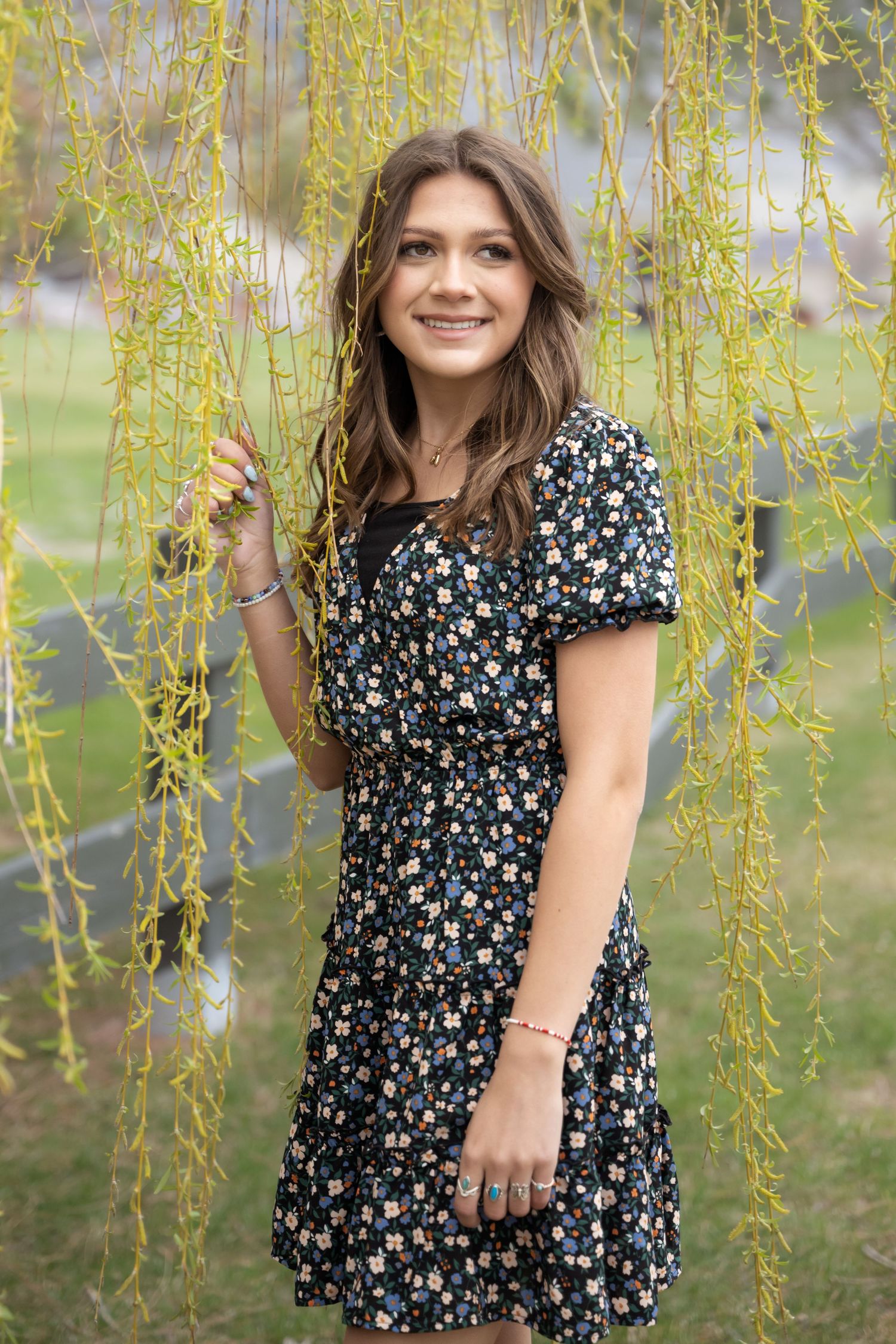 High school senior girl smiling during an outdoor senior photography session in Utah.