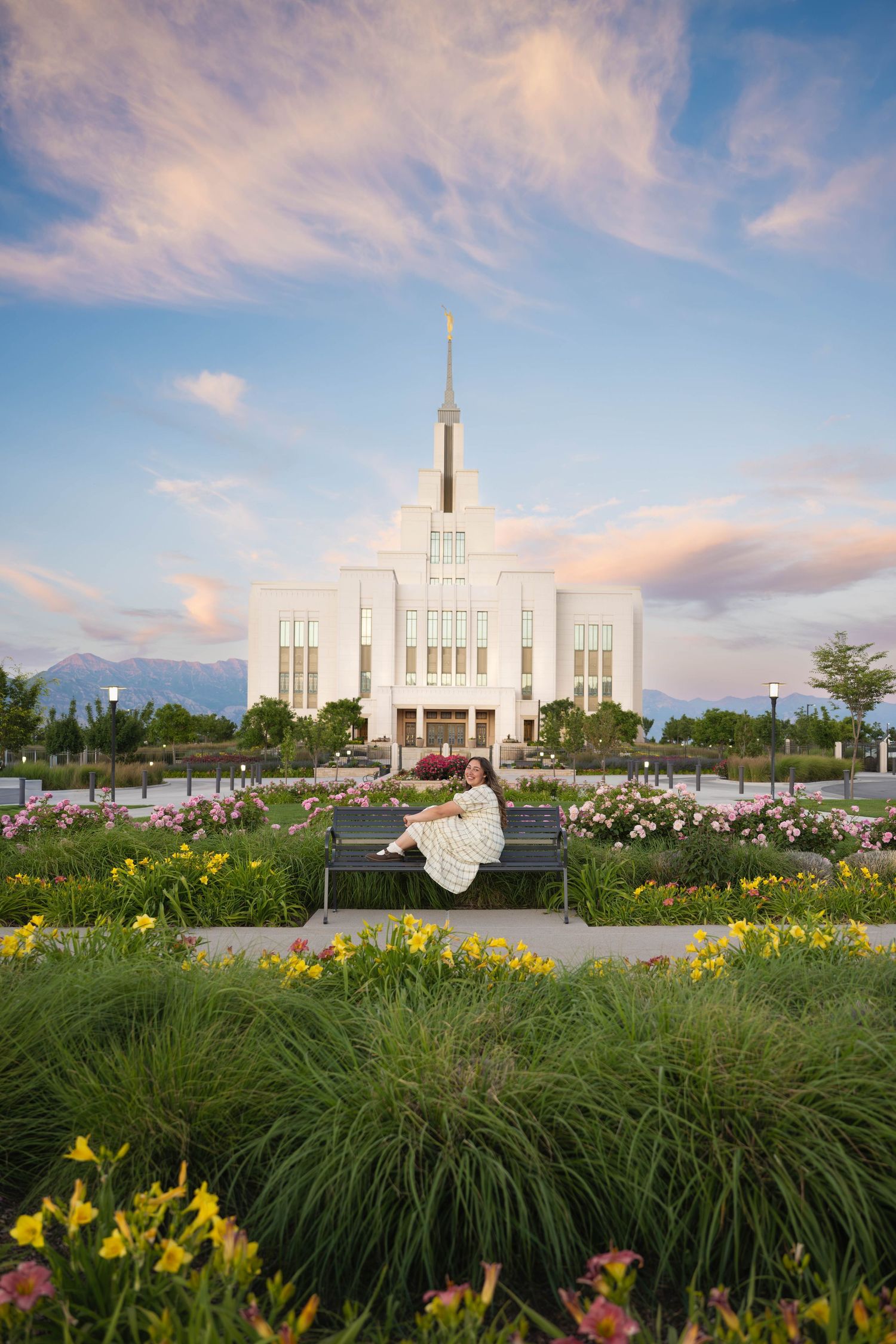 Beautiful Saratoga Springs,Utah temple surrounded by colorful skies and gardens during sunset missionary session.