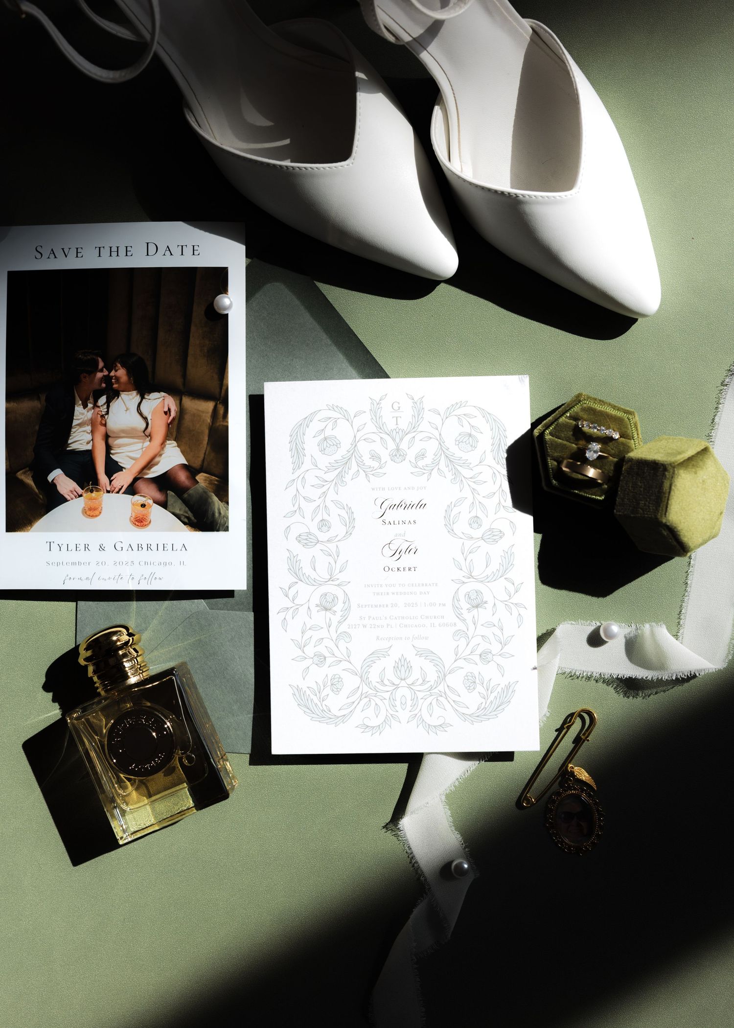 Wedding invitation and save the date cards arranged artistically with dramatic lighting and shadows.