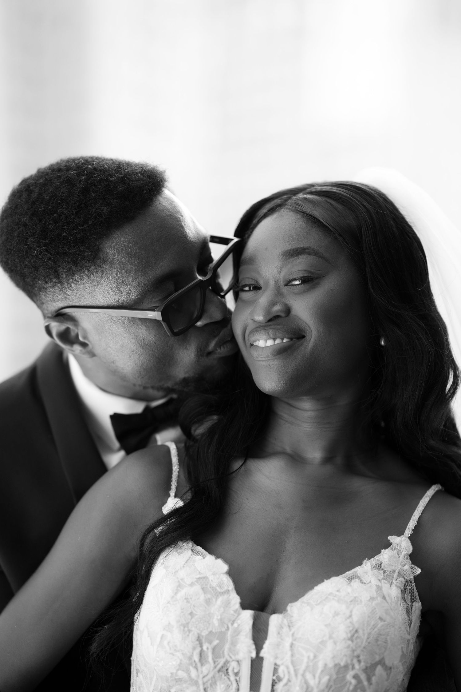 Black and white intimate wedding portraits showing tender moments between newlyweds.