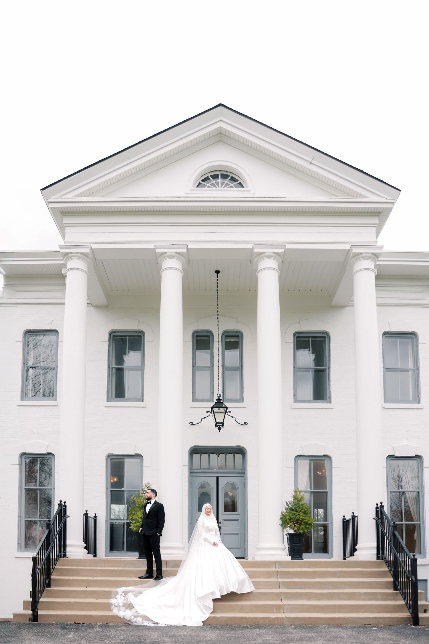 Elegant white mansion with columns and grand entrance serving as a wedding venue.