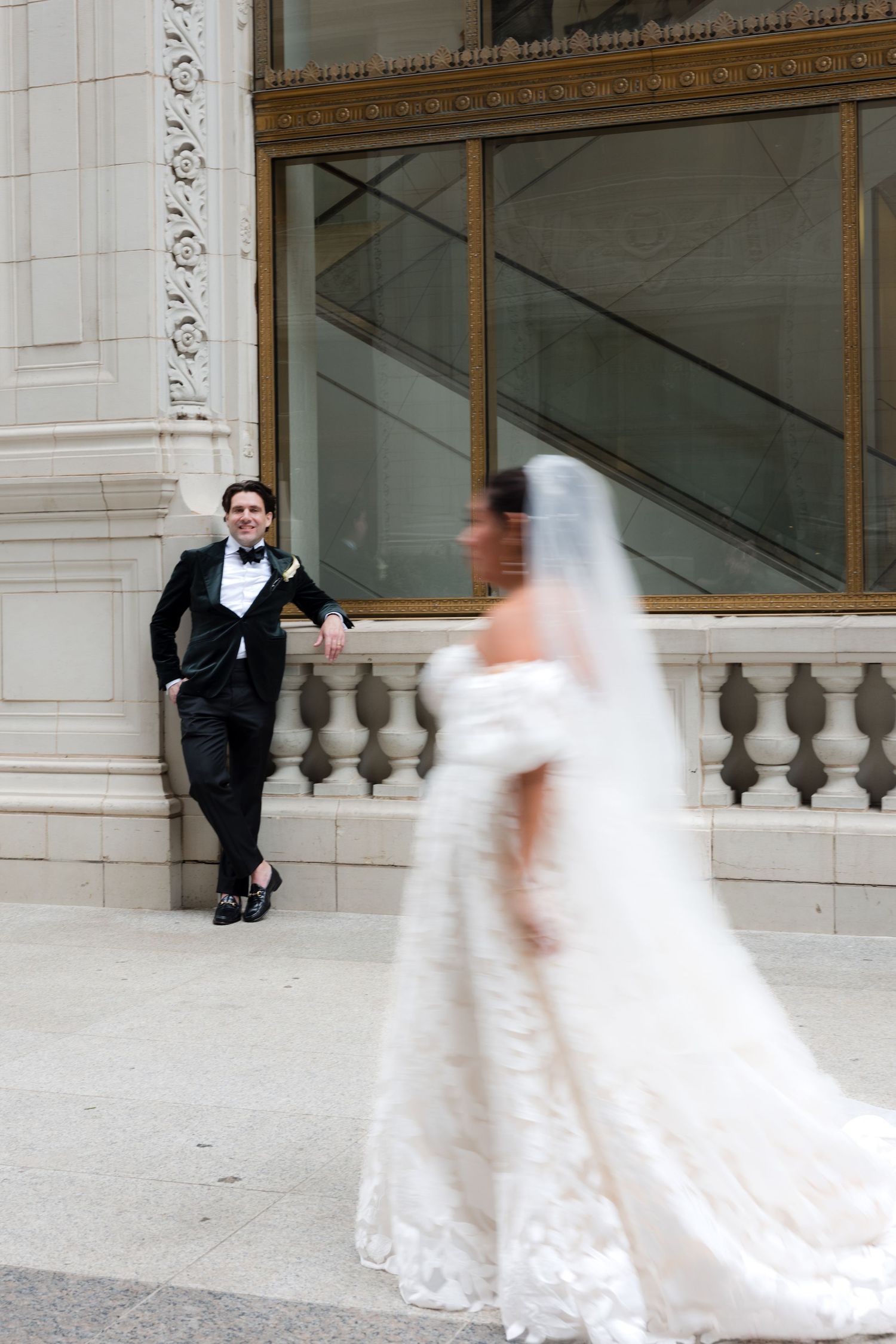 Artistic motion blur sequence of a wedding couple dancing outside a grand building.