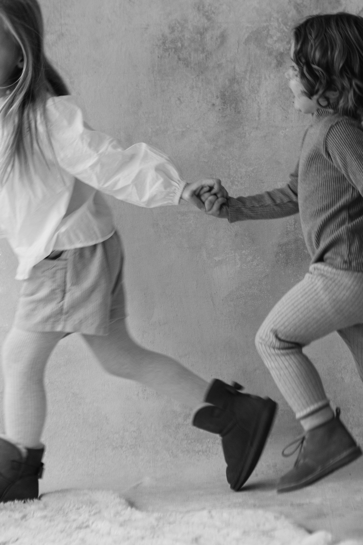 A sequence of dance-like movements showing flowing white fabric against a gray background.