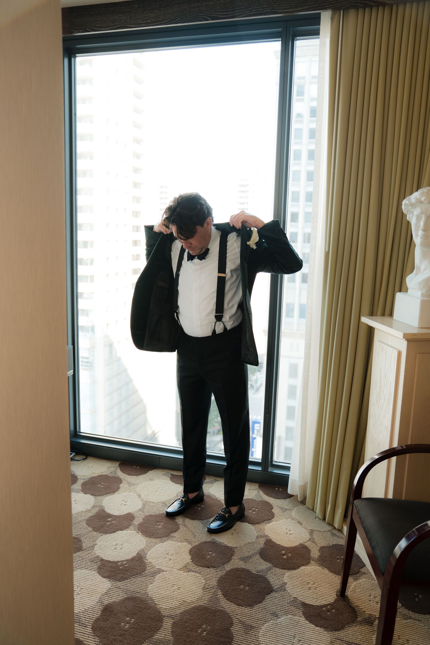 Series of playful poses near a large window in formal attire.