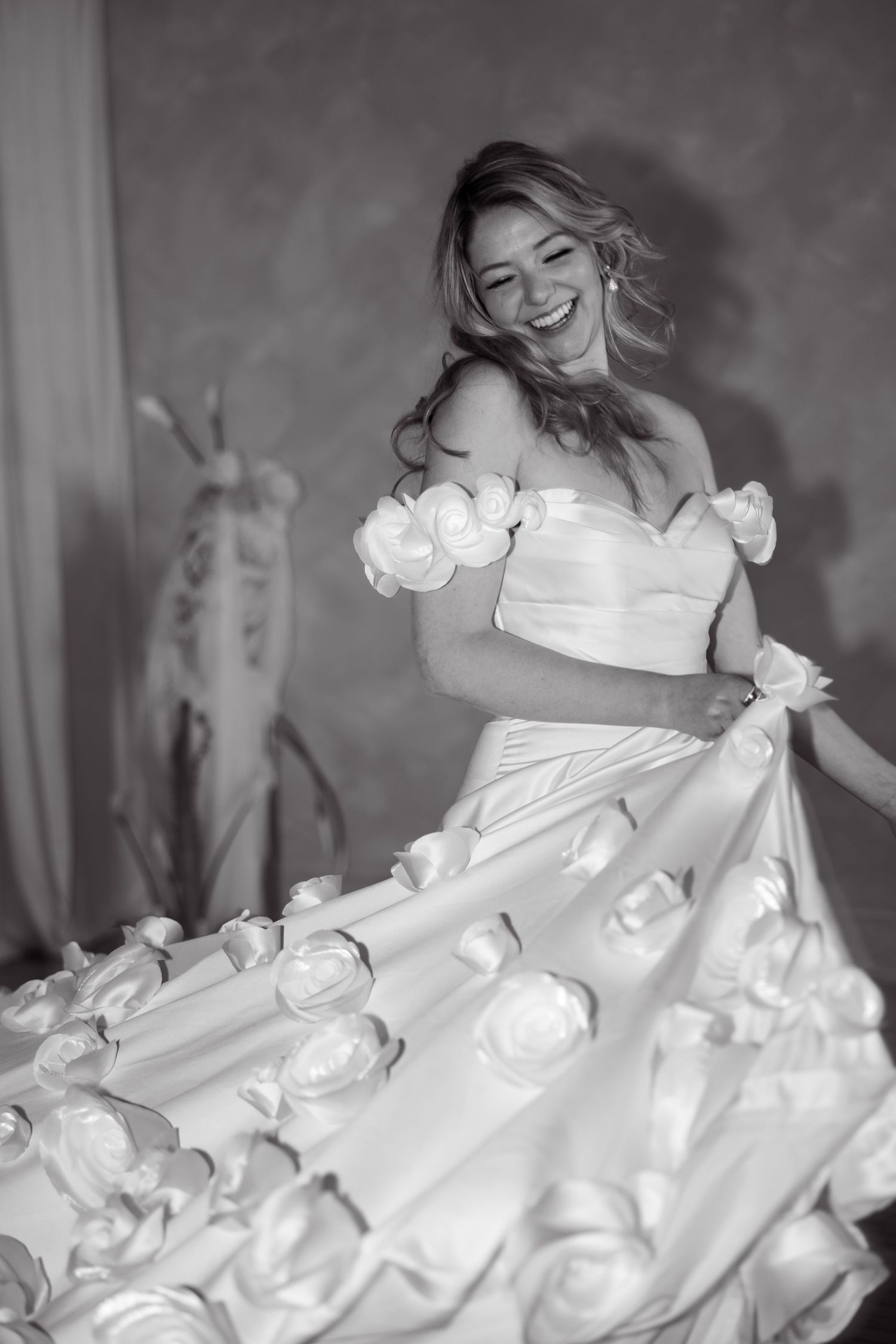 Sequence of artistic black and white photos showing flowing white wedding dress in motion.