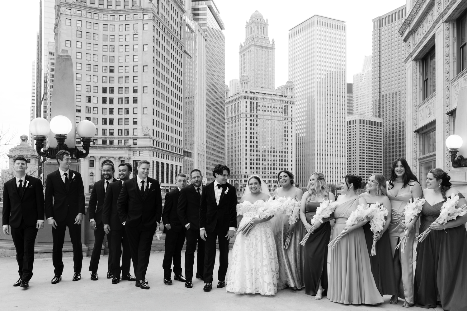 Wedding party lined up with Chicago city skyline in background.