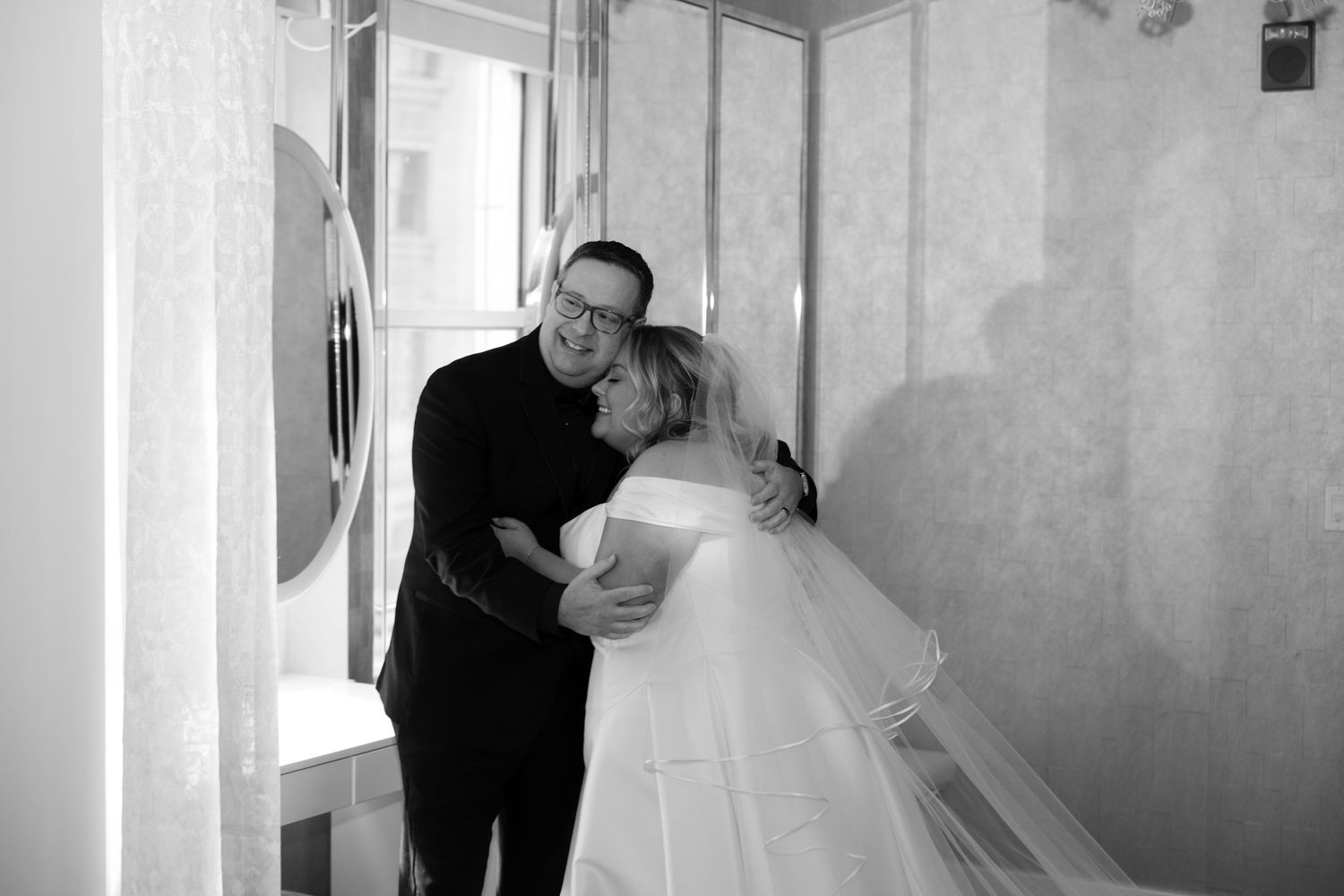 Wedding dress preparations in a bridal suite with elegant white gown.